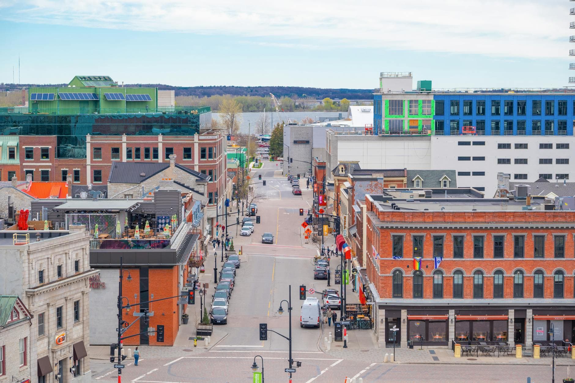 A vibrant aerial view of Kingston's bustling downtown with colorful architecture on a bright day.
