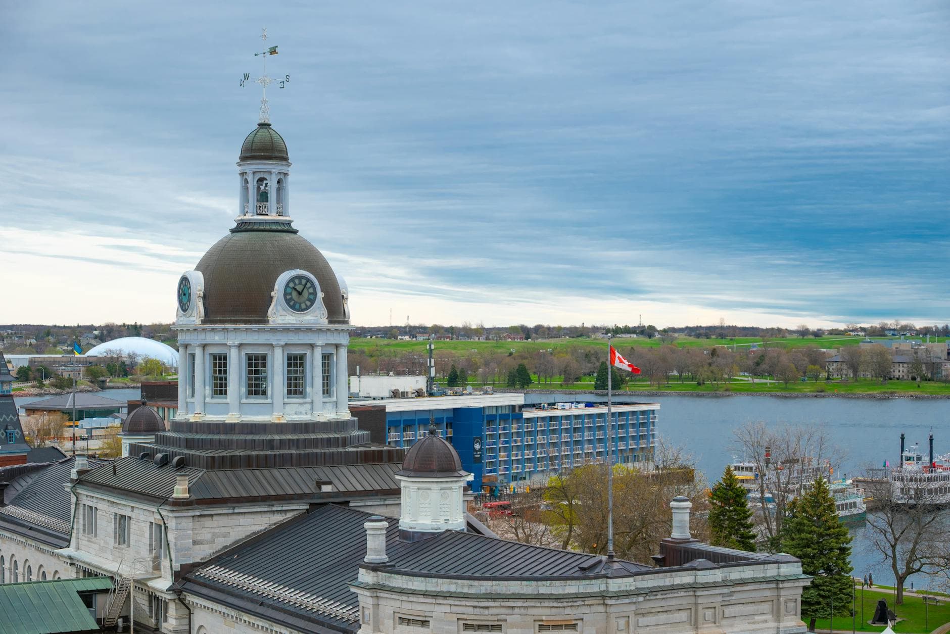 A picturesque view of Kingston City Hall by the harbor, capturing architectural beauty and Canadian scenery.