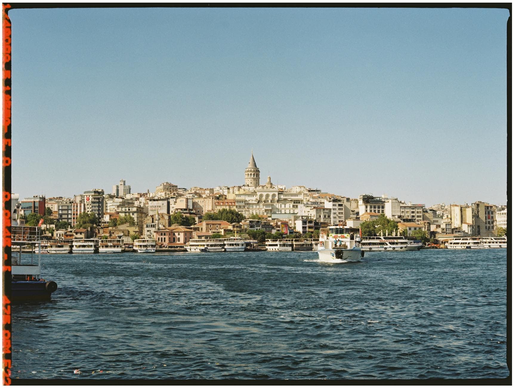 Scenic view of Istanbul's Galata Tower and city skyline from the waterfront.