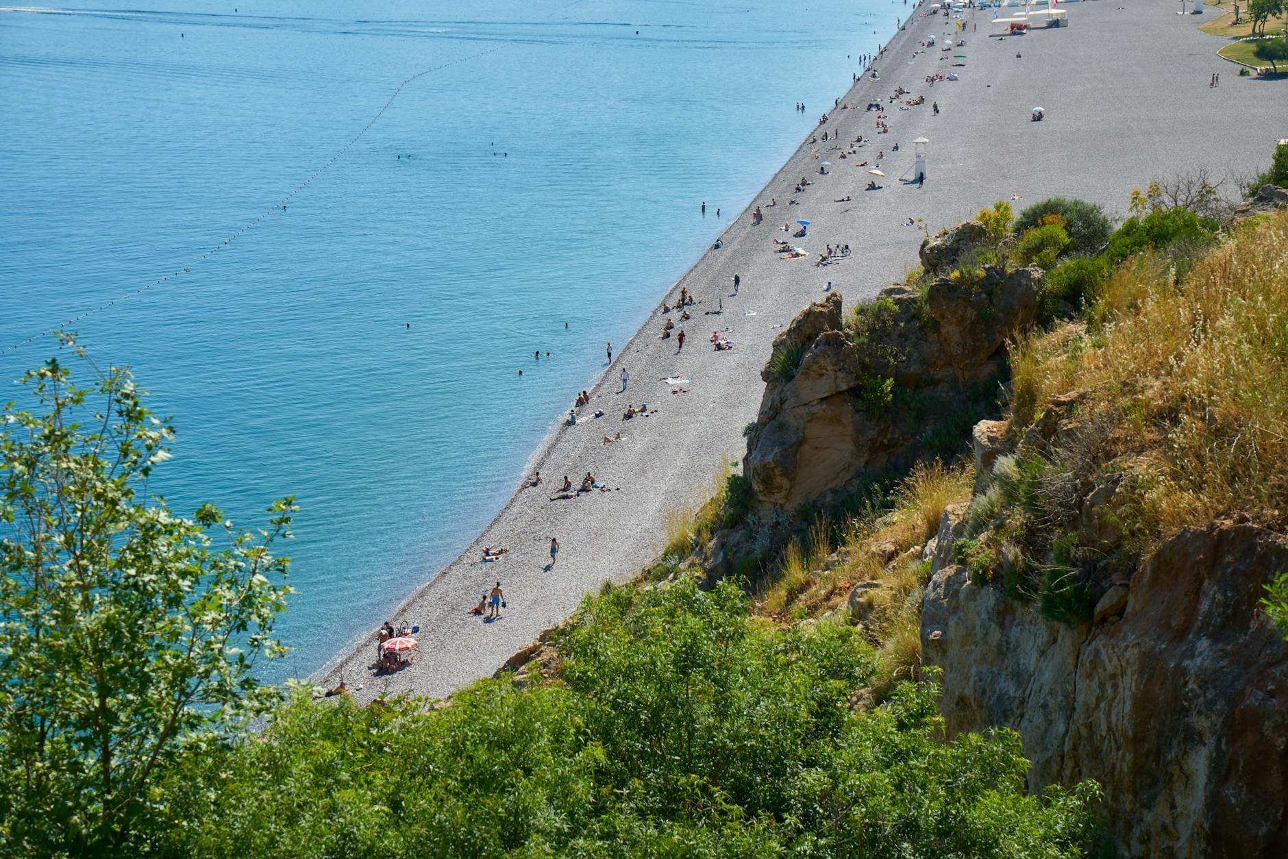 Breathtaking aerial view of Konyaaltı Beach in Antalya, Turkey with turquoise waters and vibrant activity.