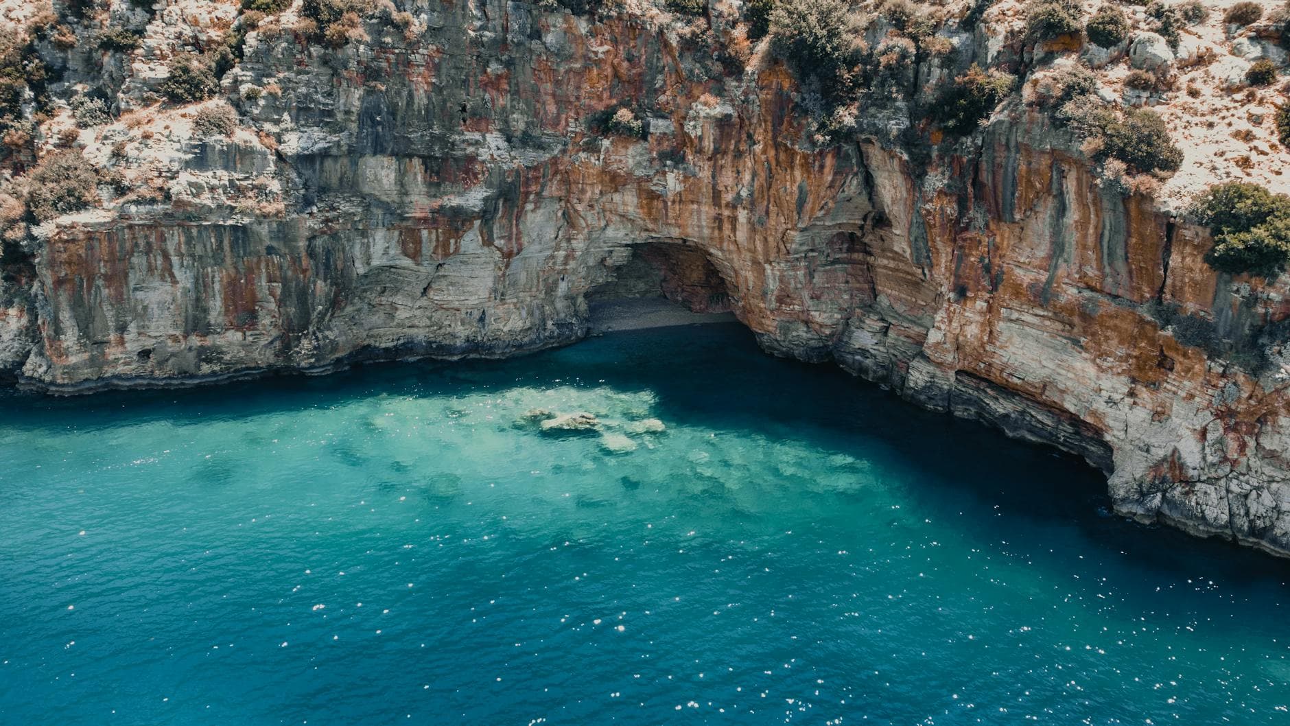 Breathtaking view of a turquoise cove with rocky cliffs in Finike, Antalya, Turkey.