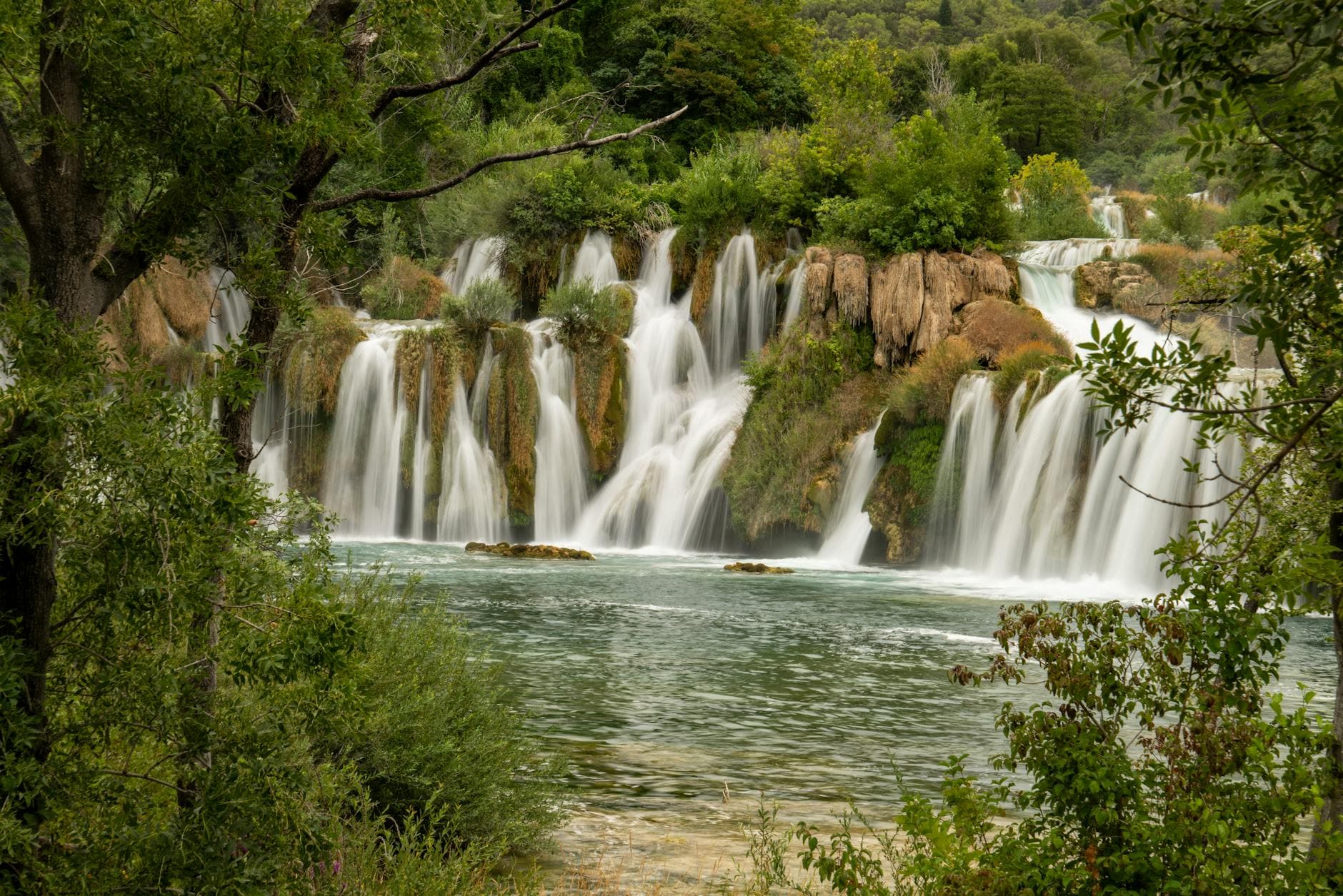Stunning view of cascading waterfalls in lush Krka National Park, Croatia.