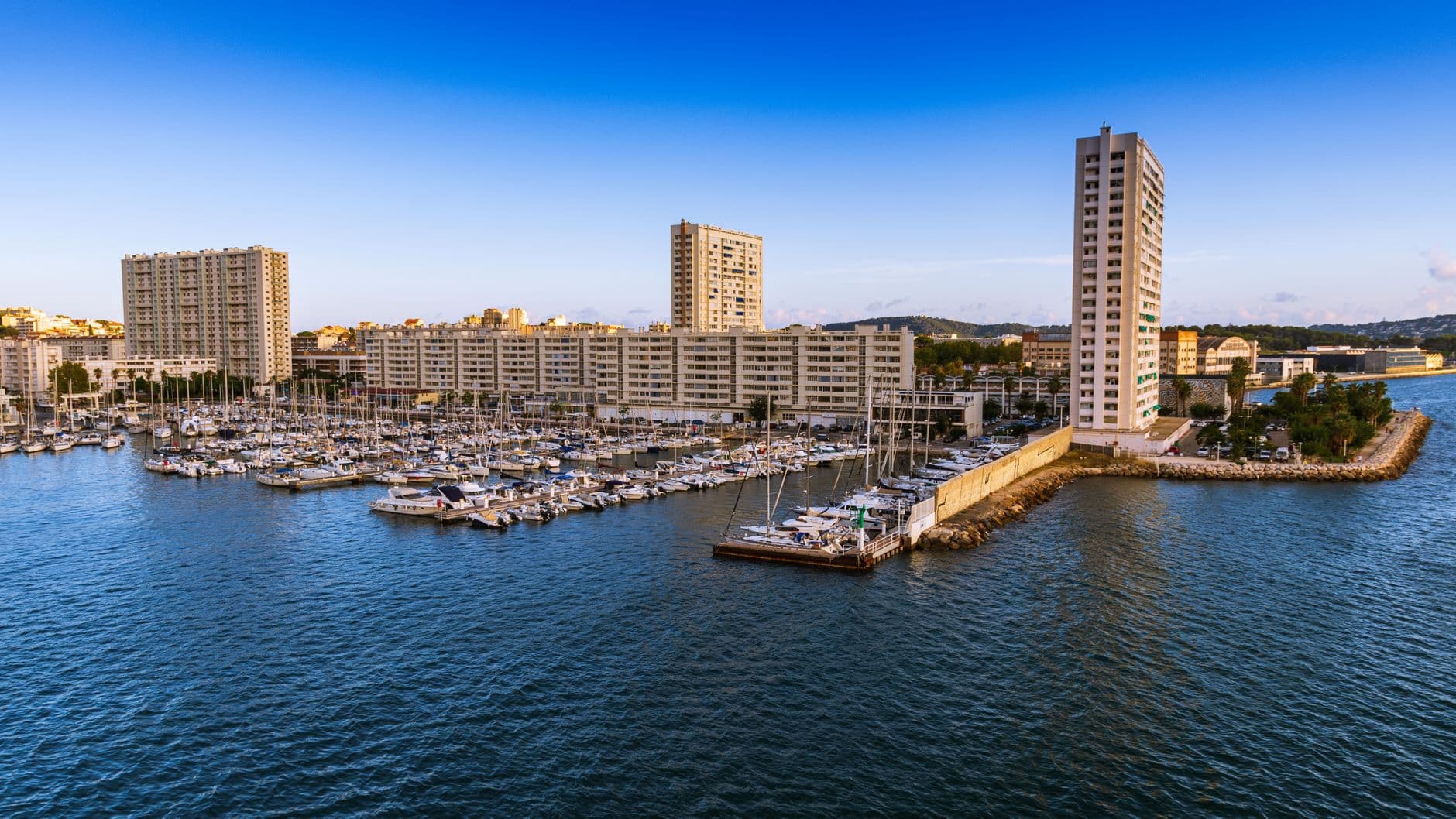 Aerial view of Toulon's marina showcasing yachts and waterfront skyline in Provence, France.