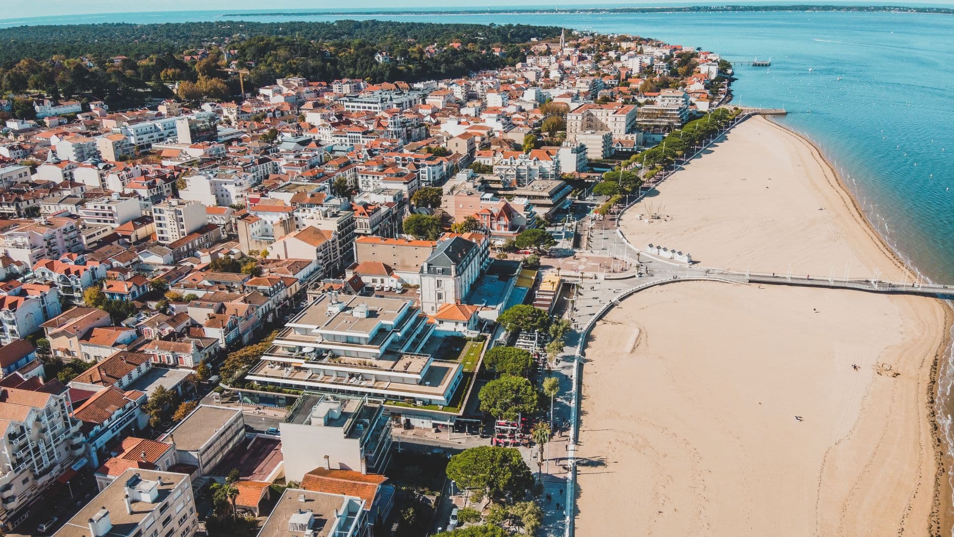 Stunning aerial view of Arcachon, France, featuring sandy beaches and city architecture.