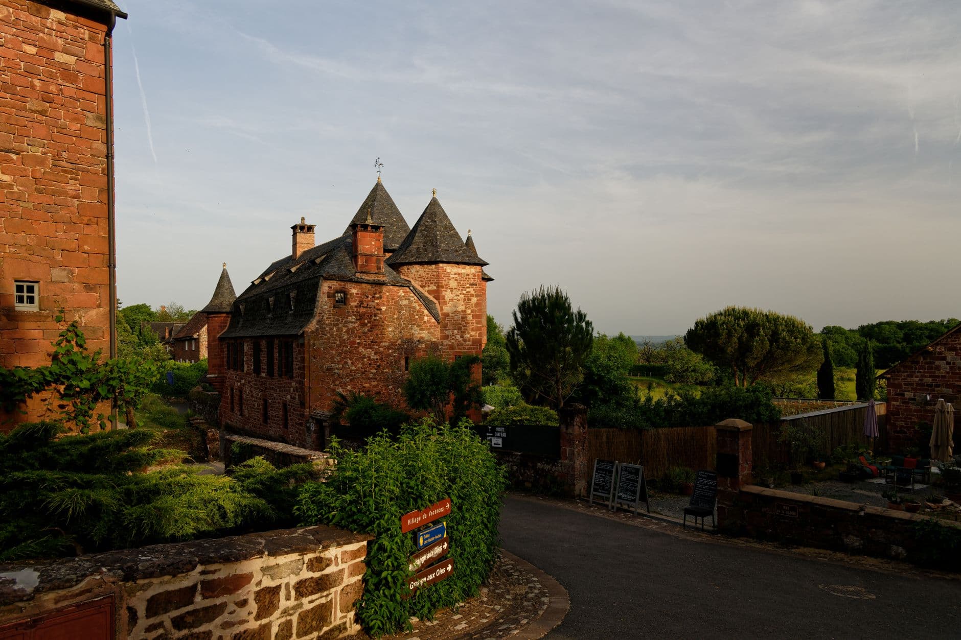 Explore the picturesque red-brick architecture of Collonges-la-Rouge, France, captured at sunset.