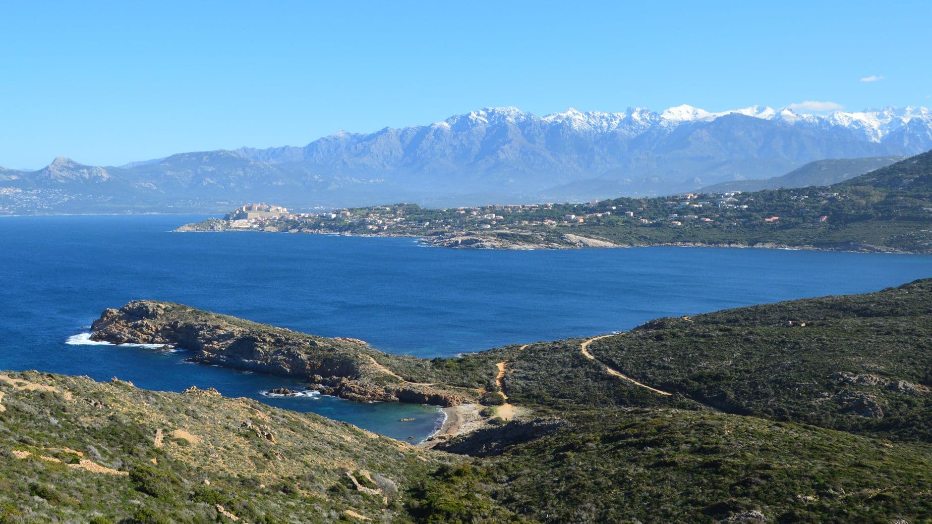 Beautiful view of the Calvi coastline with mountains and the Mediterranean Sea in Corsica, France.