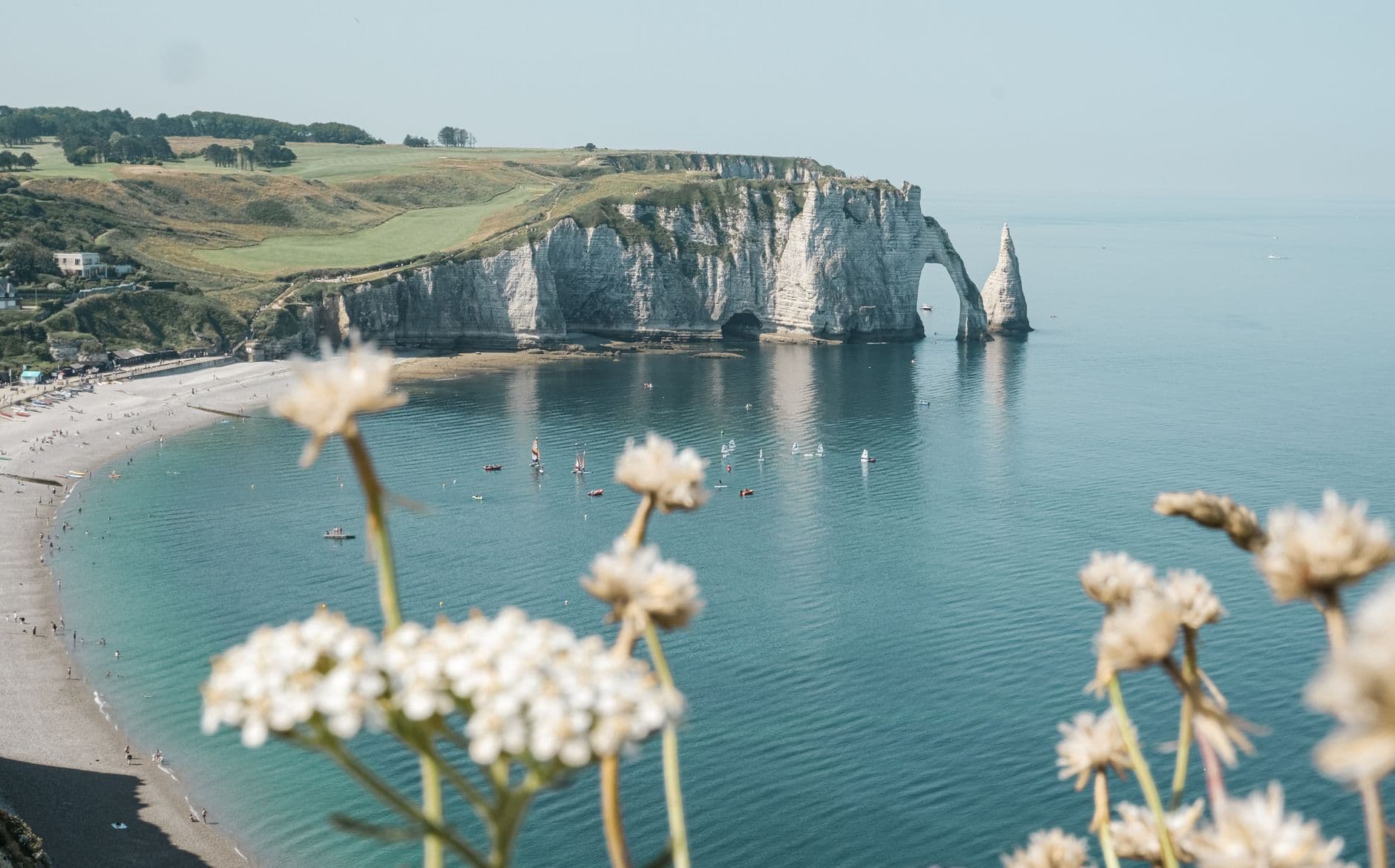 A picturesque summer view of Étretat's cliffs and seashore in Normandy, France.