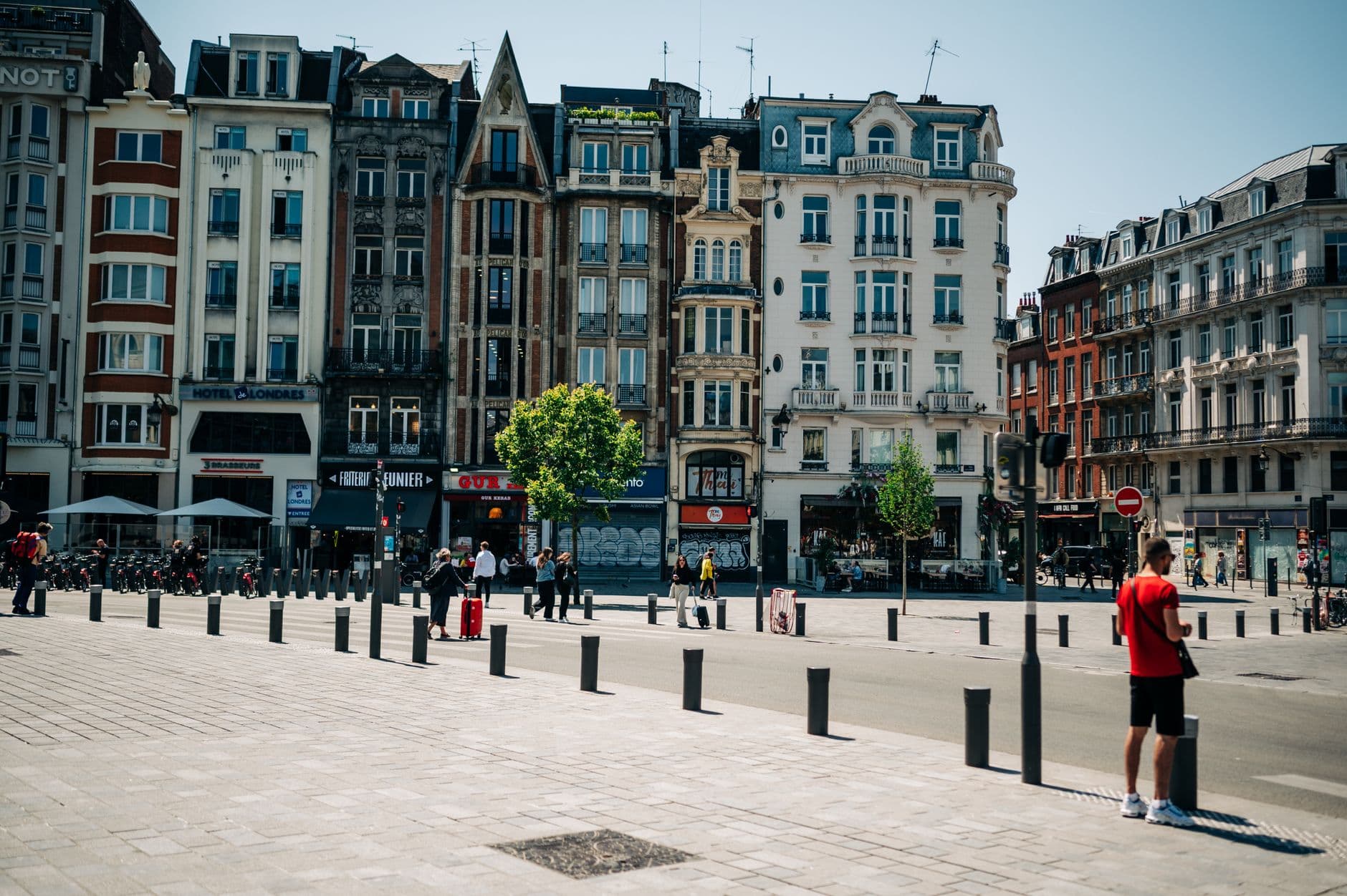 Vibrant cityscape of old town Lille, France, showcasing historic townhouses and lively urban atmosphere.
