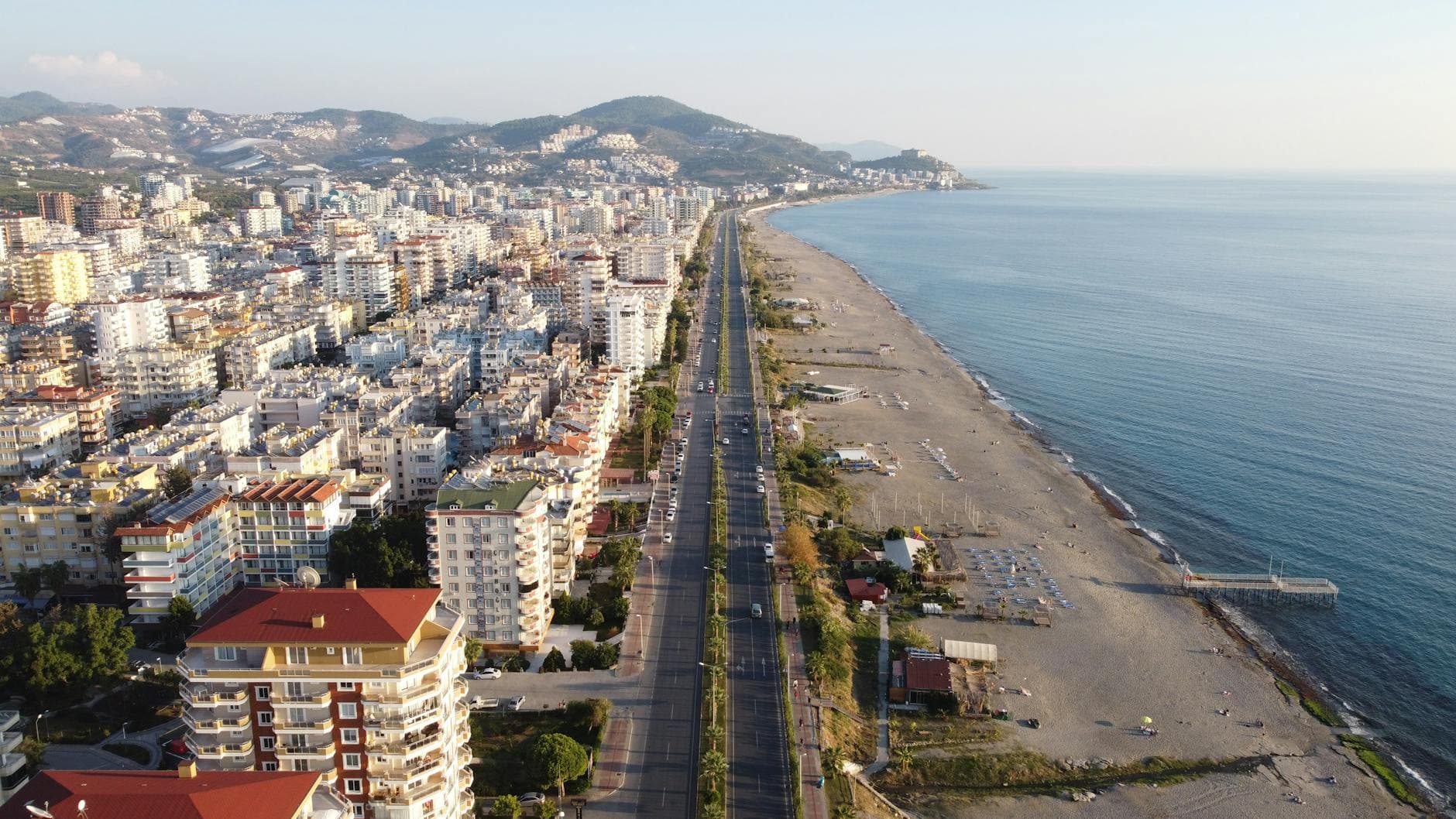 Aerial view showcasing Alanya's coastline, high rises, and beaches in Turkey.