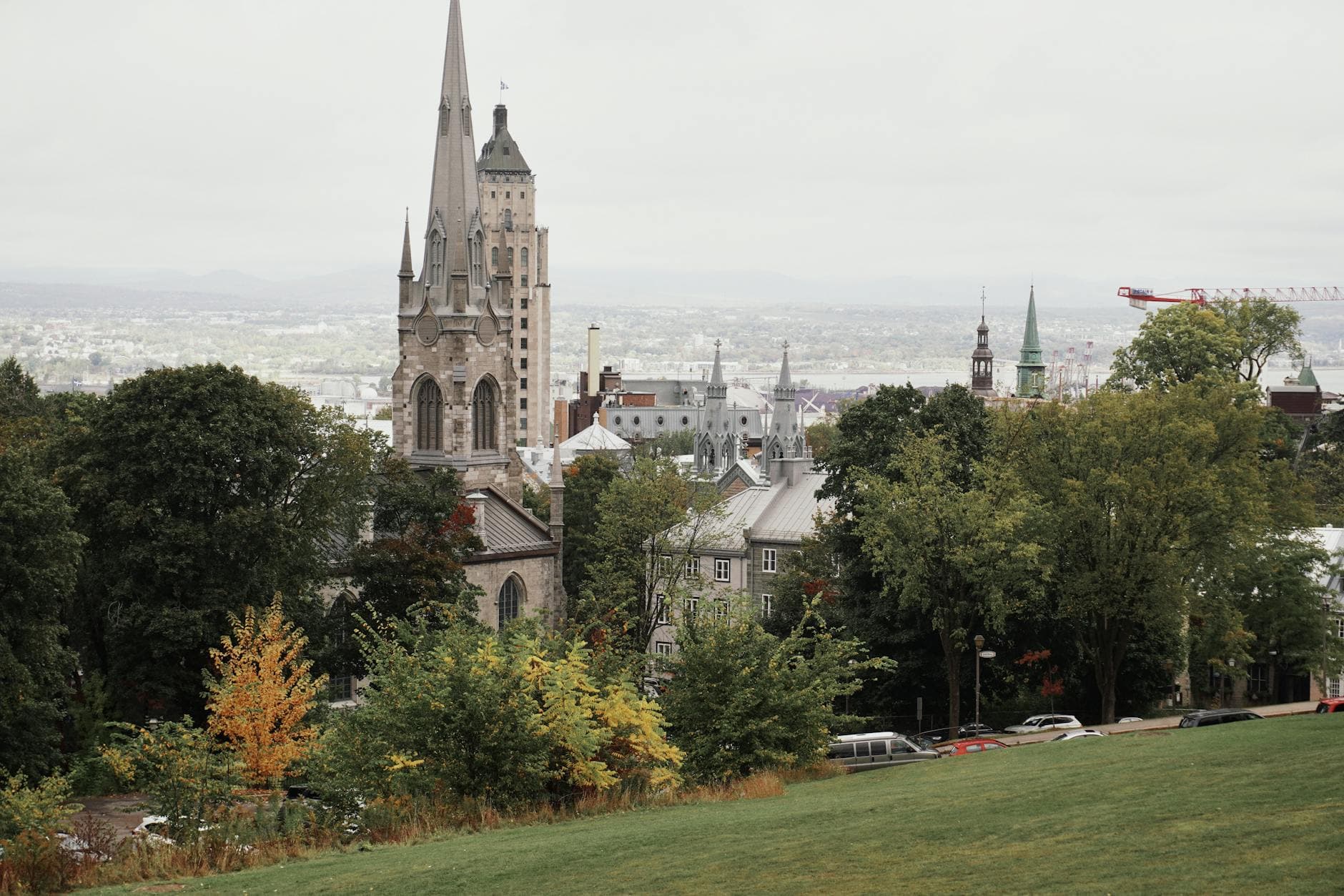 A picturesque view of Quebec City featuring its historic church with autumn foliage.