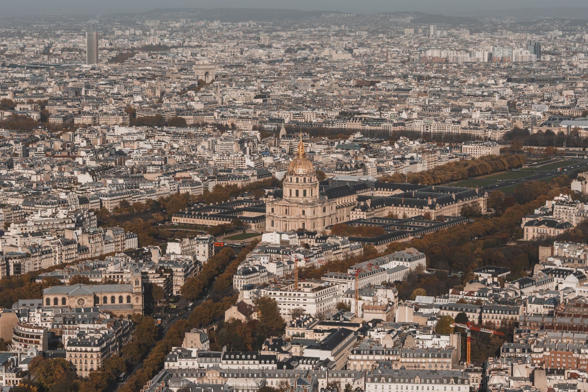 Scenic aerial shot of the historic Hôtel des Invalides amidst the Paris cityscape.