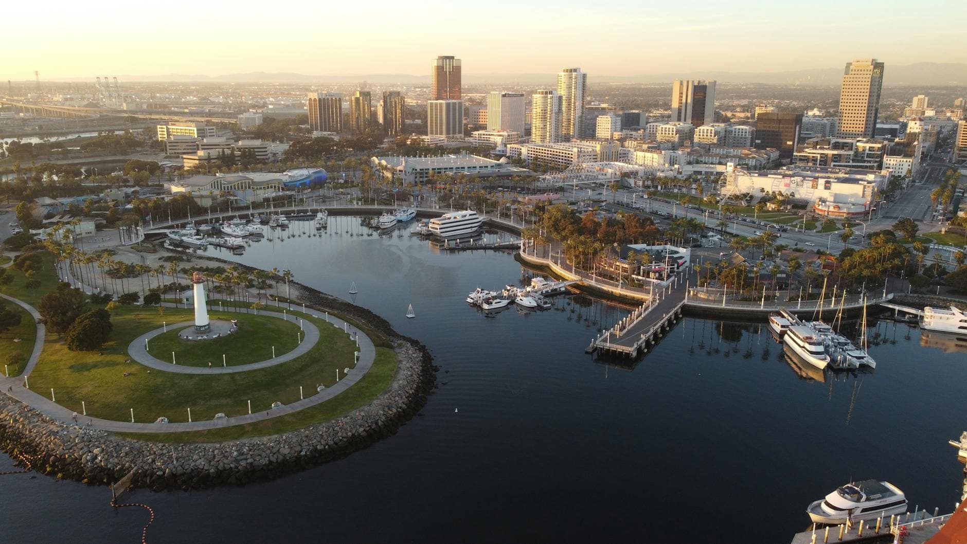 A stunning aerial shot of Long Beach Harbor, showcasing yachts and cityscape at dusk.