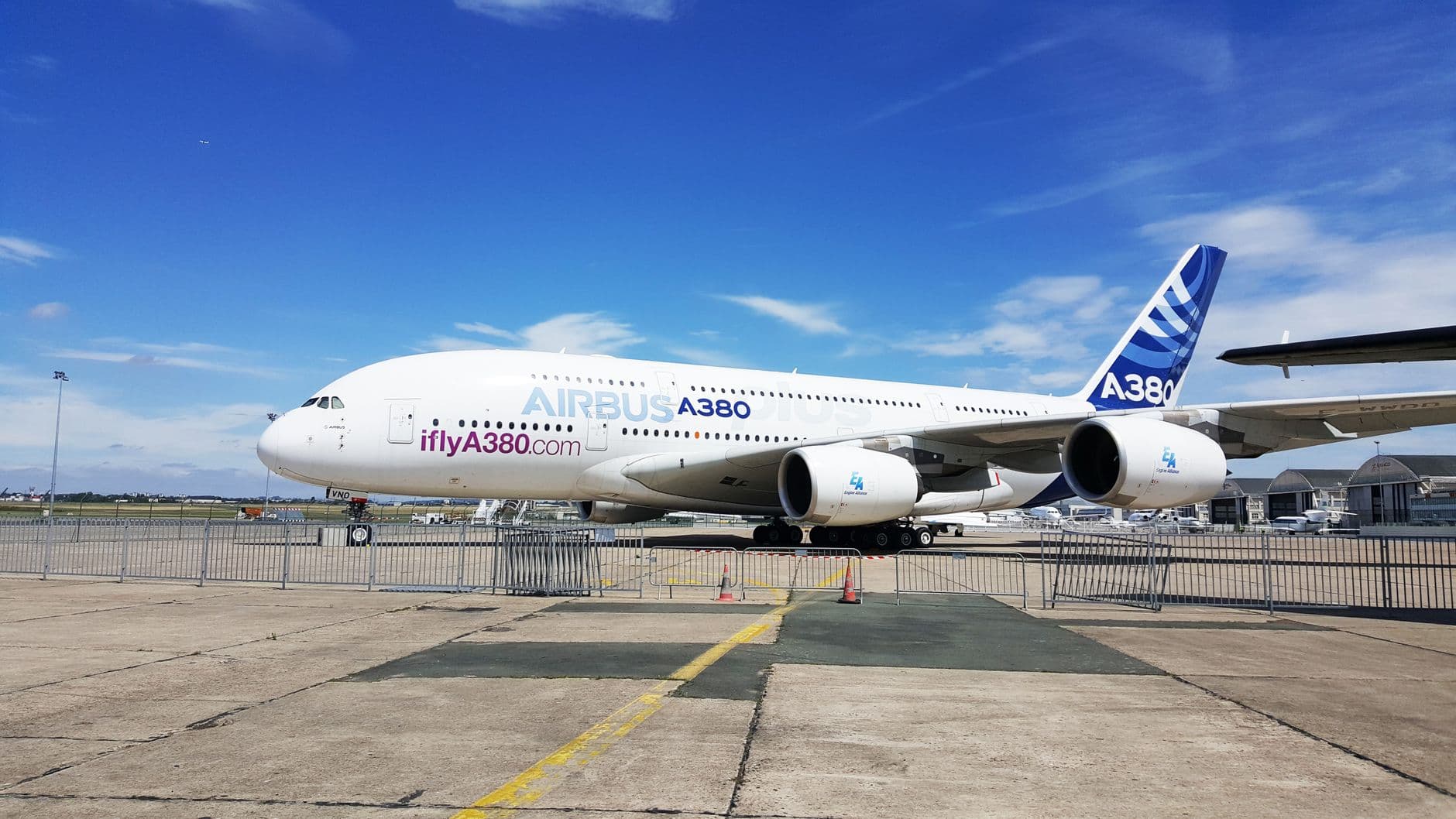 A close-up view of an Airbus A380 parked on the tarmac at a Paris airport.