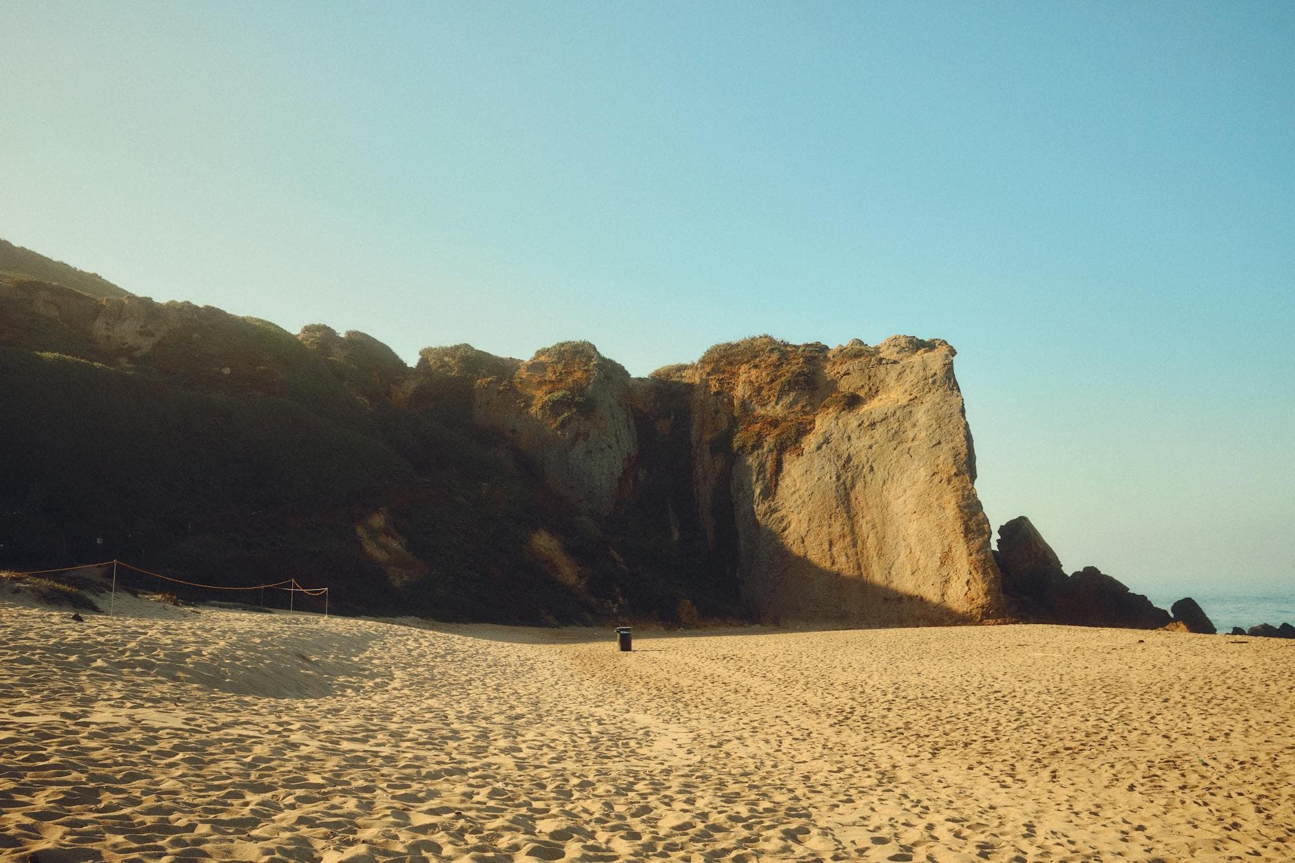 A beautiful scenic view of the sandy beach and iconic cliffs of Point Dume in Malibu, California.