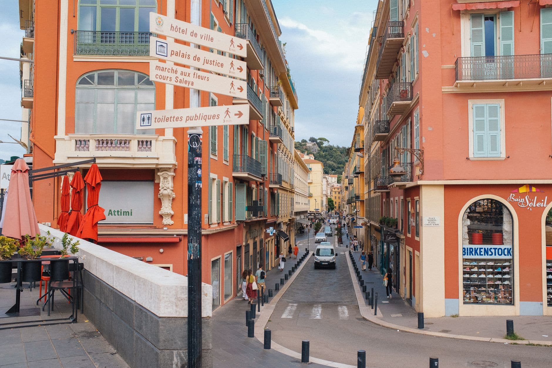 Scenic view of a vibrant street in Nice, France, featuring colorful architecture and bustling atmosphere.