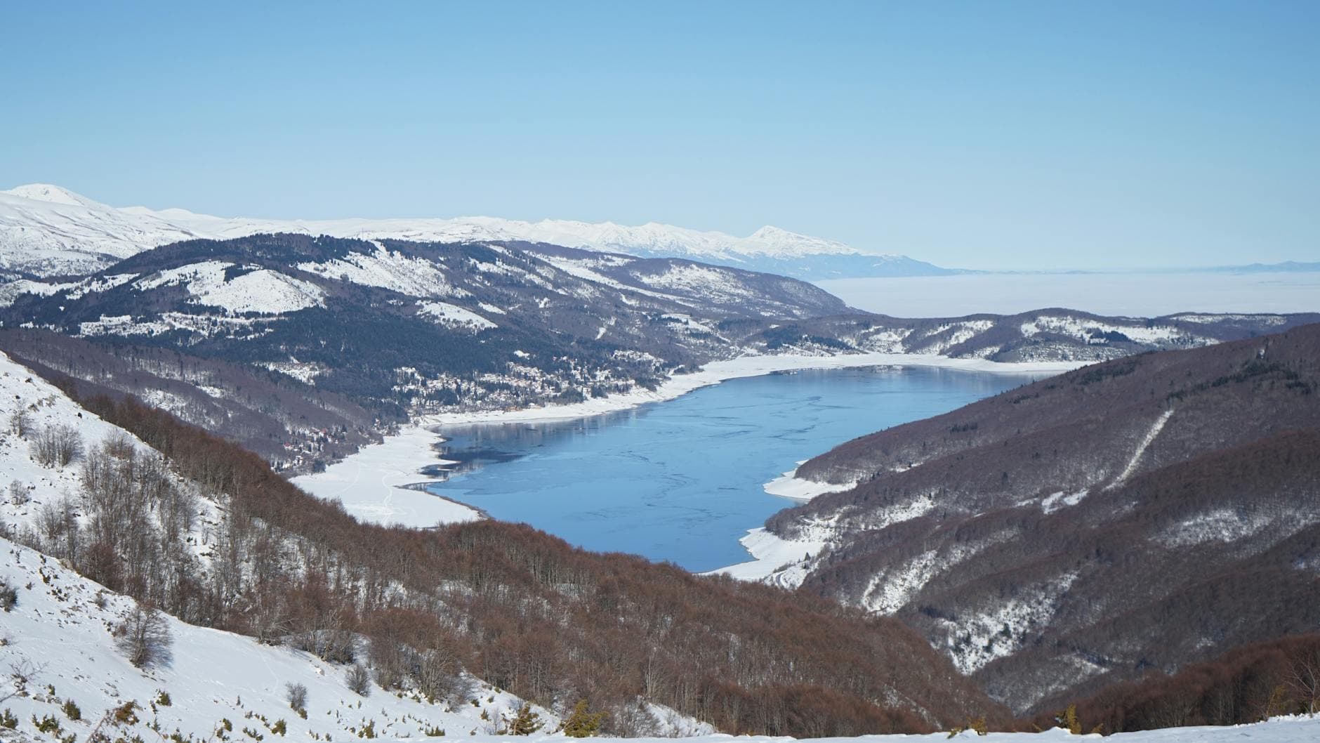 Aerial view of the snowy Mavrovo Lake in winter, North Macedonia.