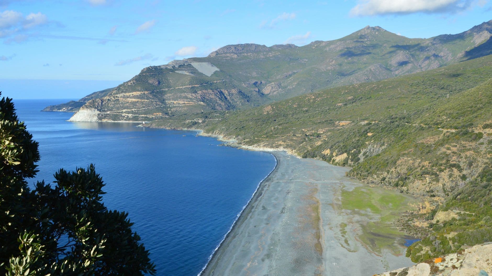 Captivating view of Nonza's rugged coastline and azure waters in Corsica, France.