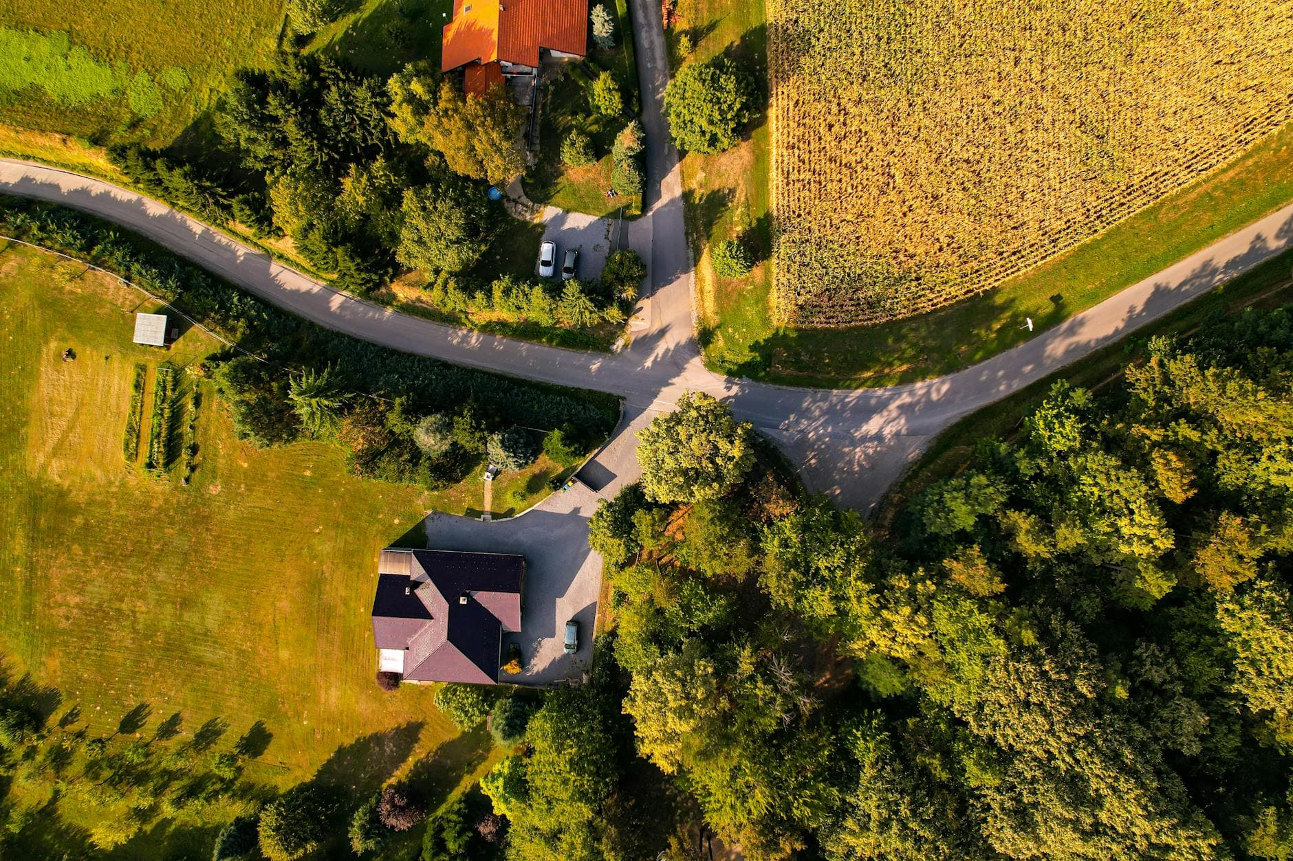 Stunning aerial photograph showcasing the rural landscape of Maglenča, Croatia, featuring lush greenery and winding roads.