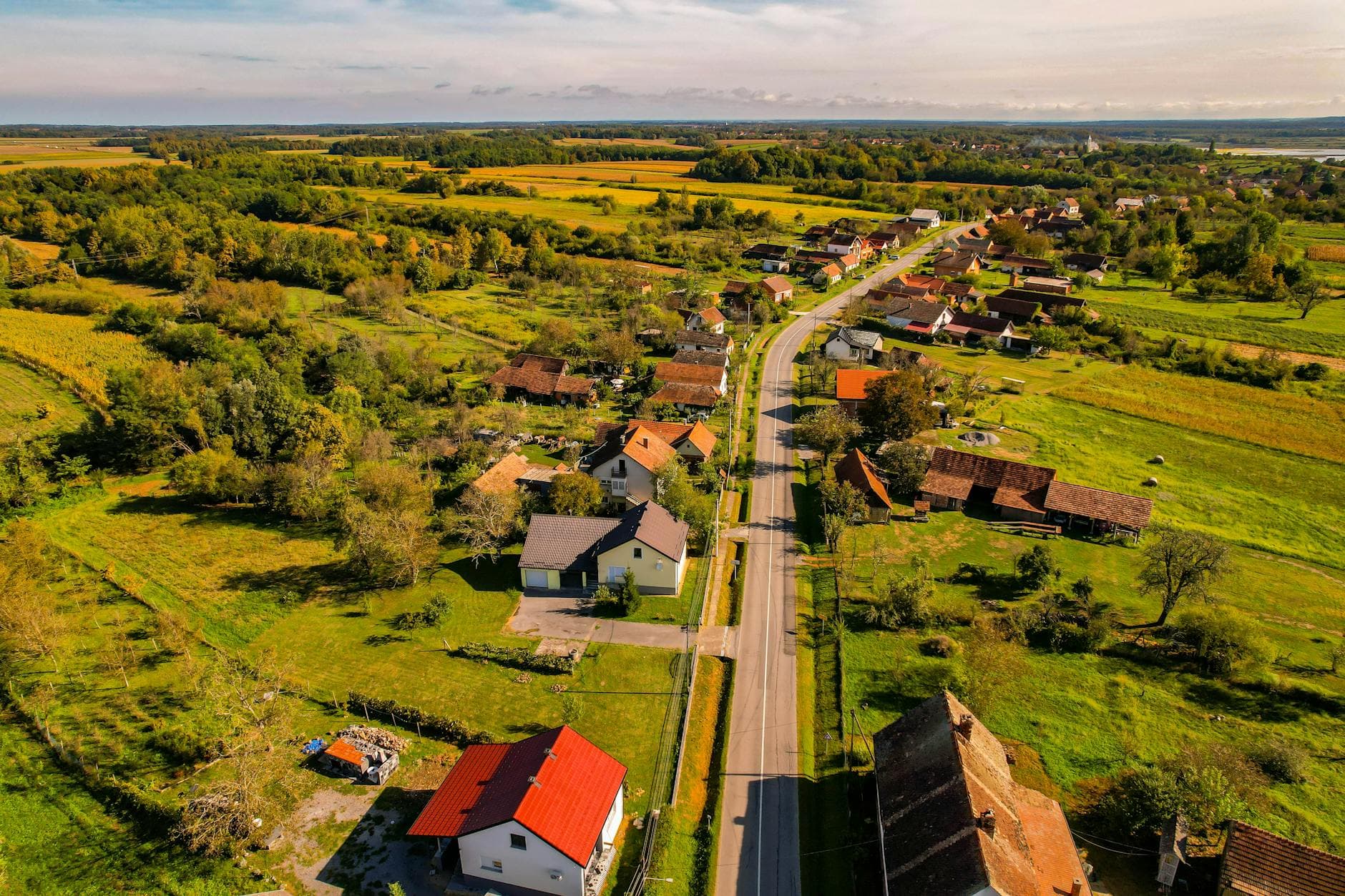 Aerial view of a picturesque rural village in Garešnica, Croatia, with lush fields and winding roads.