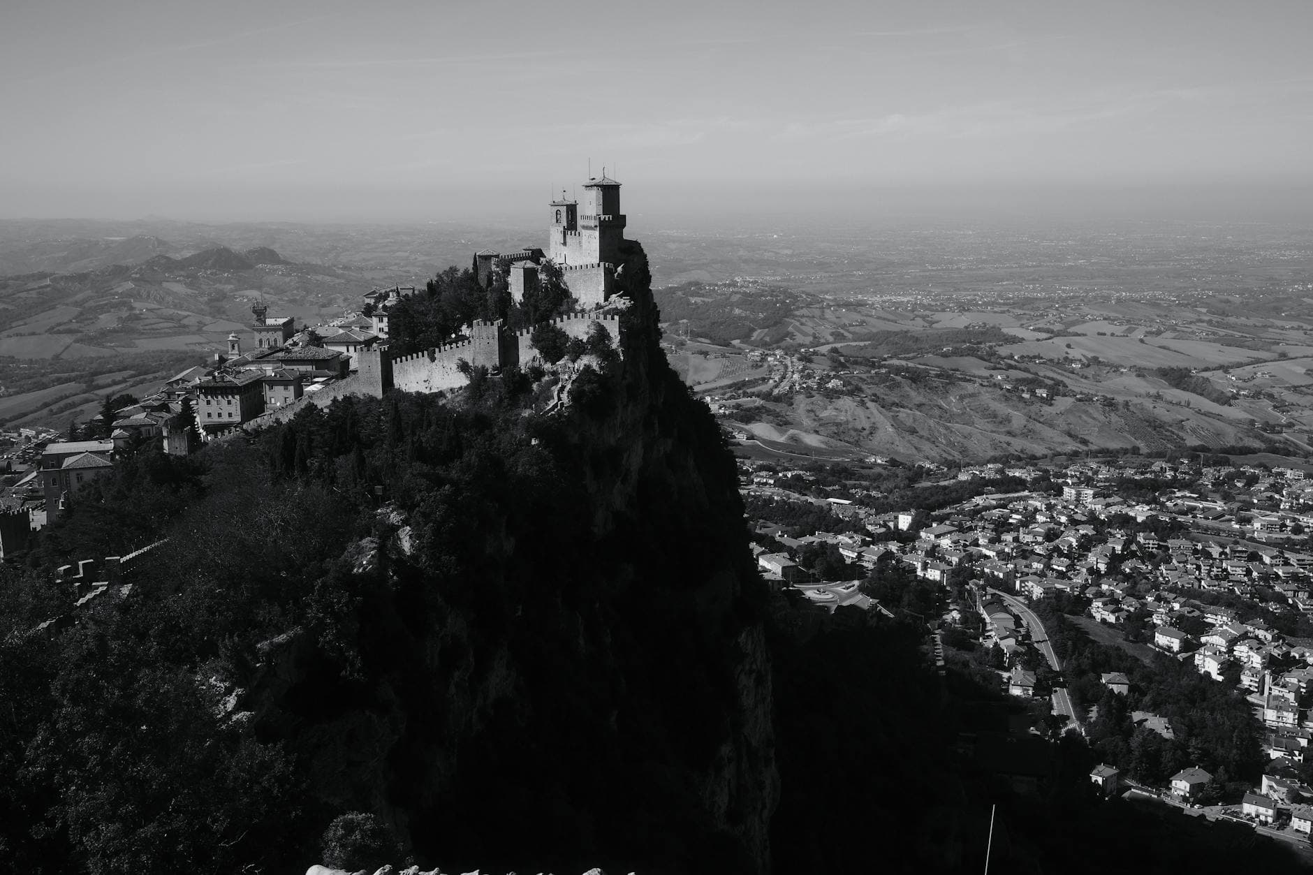 Captivating black and white aerial view of the ancient fortress and city of San Marino, Italy.
