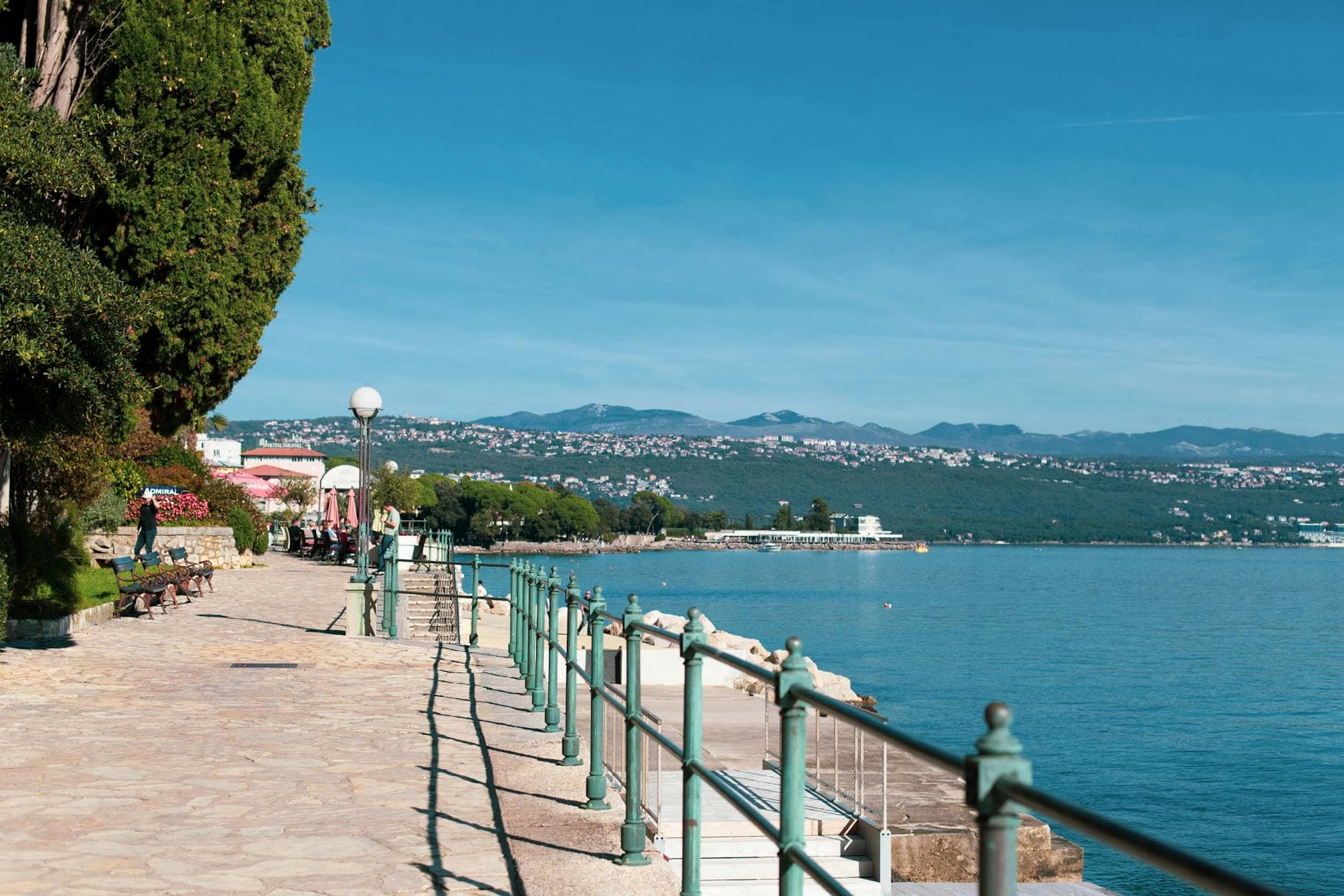 Explore the beautiful Adriatic coastline from the promenade in Opatija, Croatia featuring a summer seaside view.