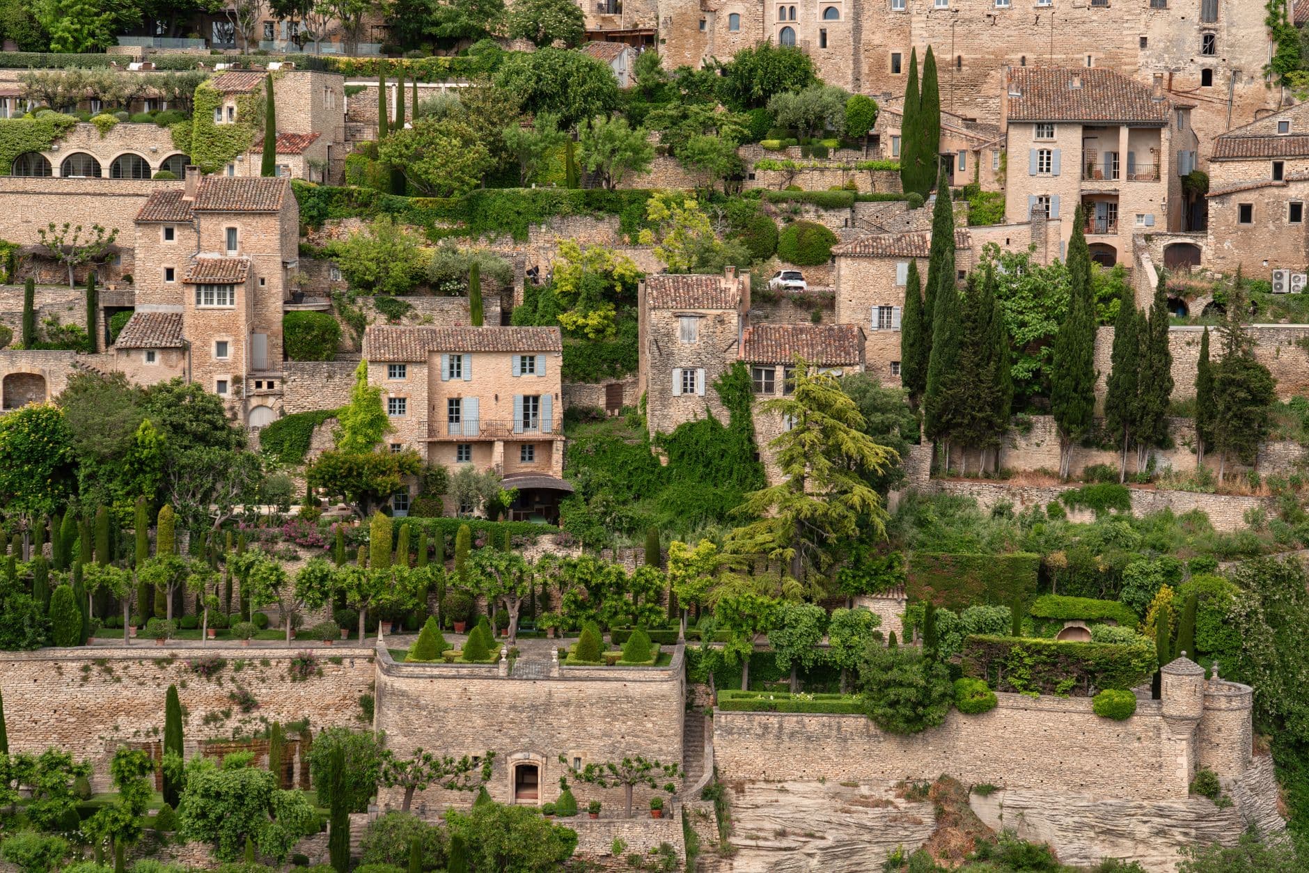 A picturesque view of a quaint European village with lush greenery and classic architecture.