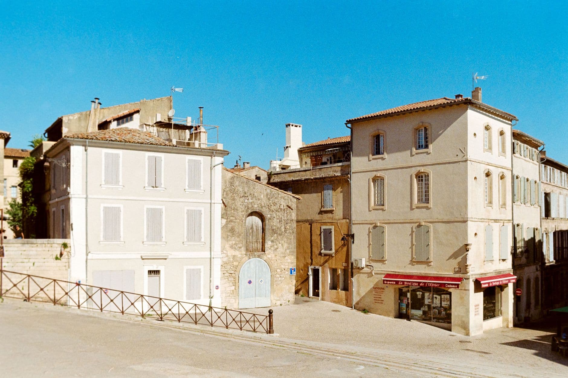 Scenic view of historic buildings under a bright blue sky in Arles, Provence-Alpes-Côte d'Azur, France.