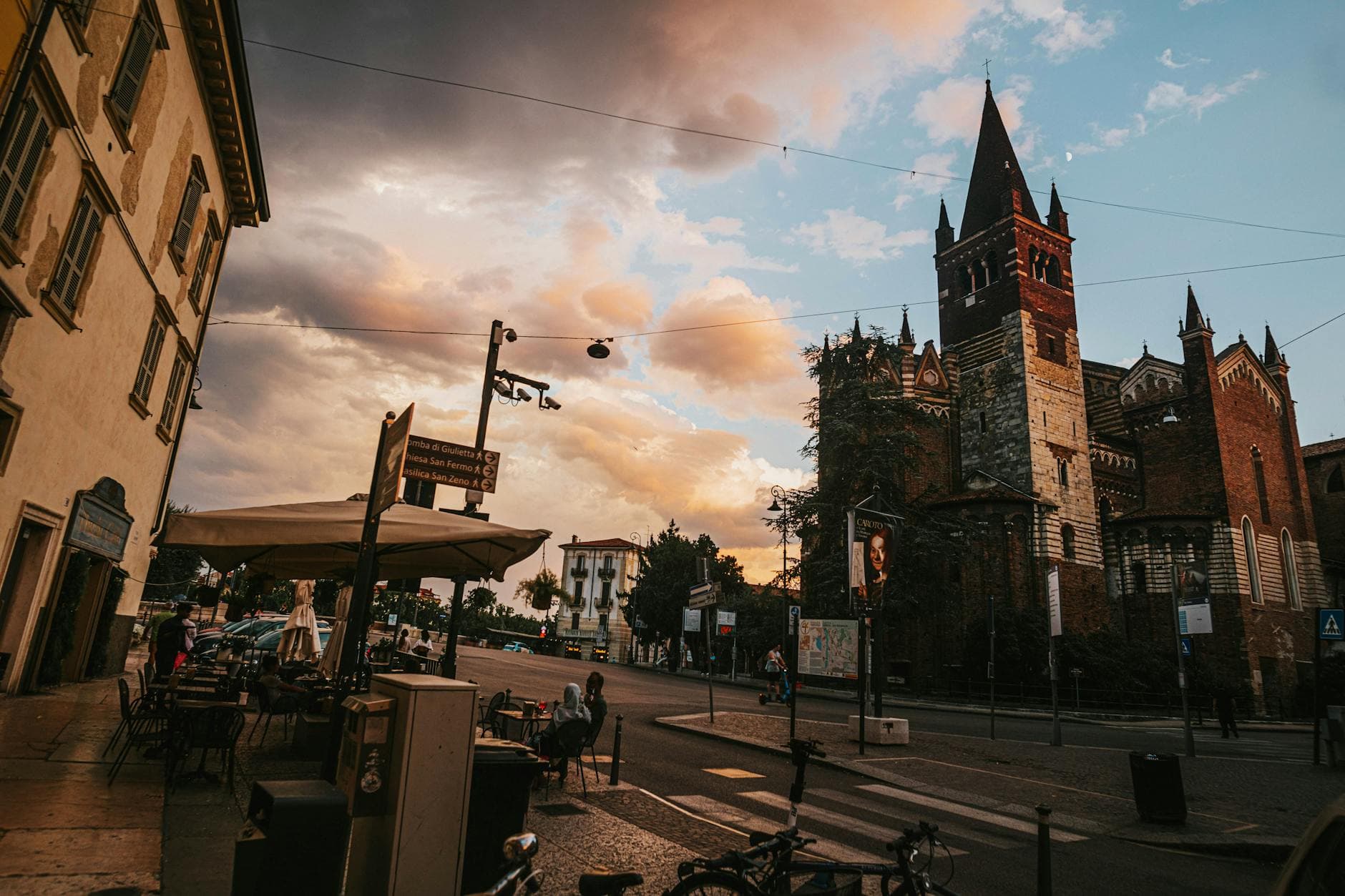 Atmospheric street view of historic church and buildings in Verona, Italy at dusk.