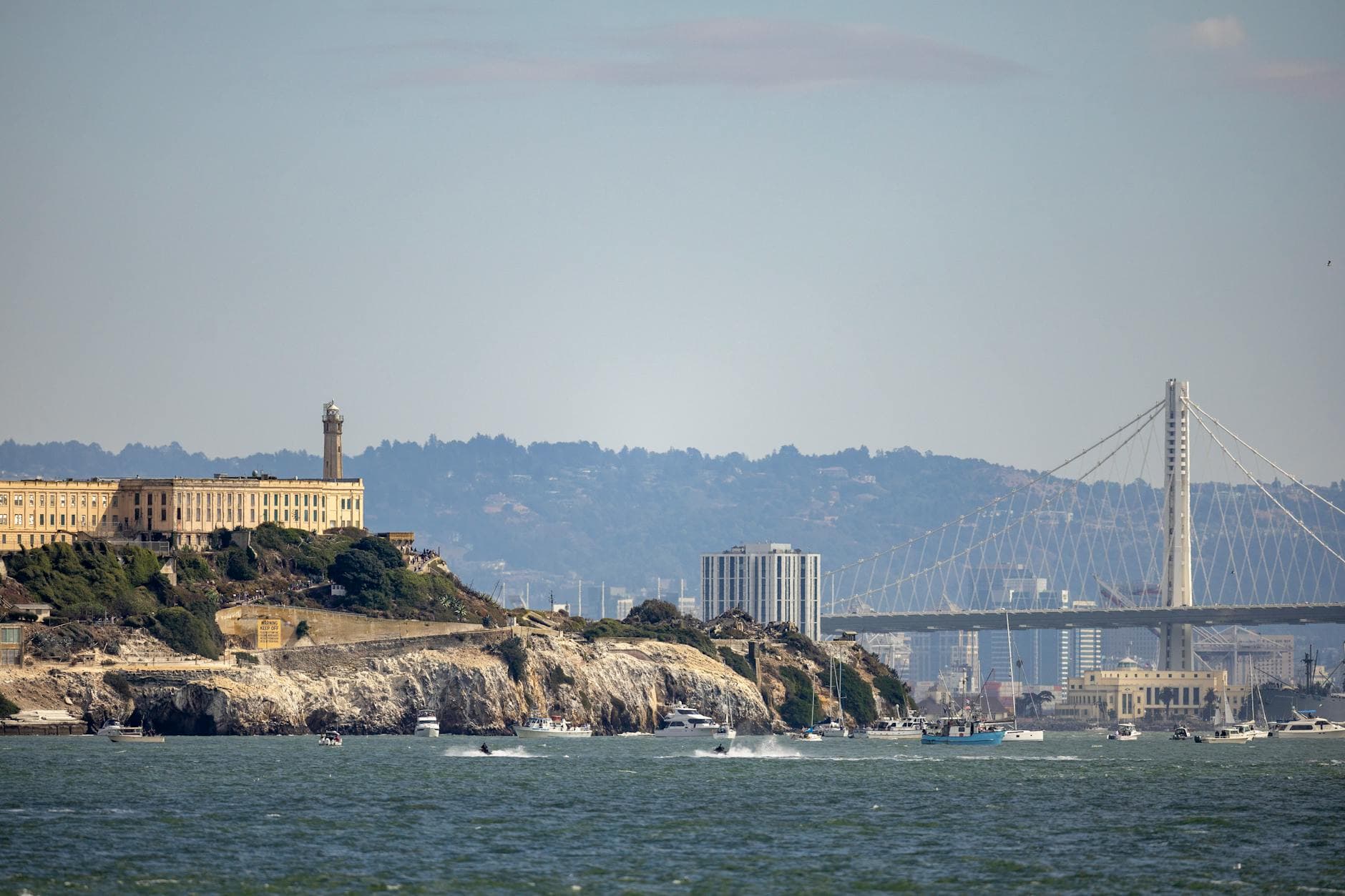 A scenic view of Alcatraz Island with the Bay Bridge in the background, San Francisco.
