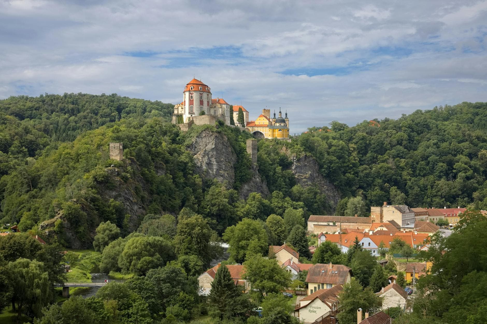 Marvel at the historic Vranov nad Dyjí Castle perched on a hill surrounded by lush greenery.