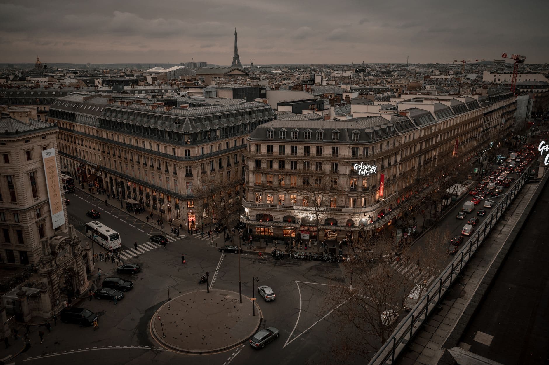 Stunning aerial view of Paris streets at dusk with the iconic Eiffel Tower in the background. Captivating cityscape.