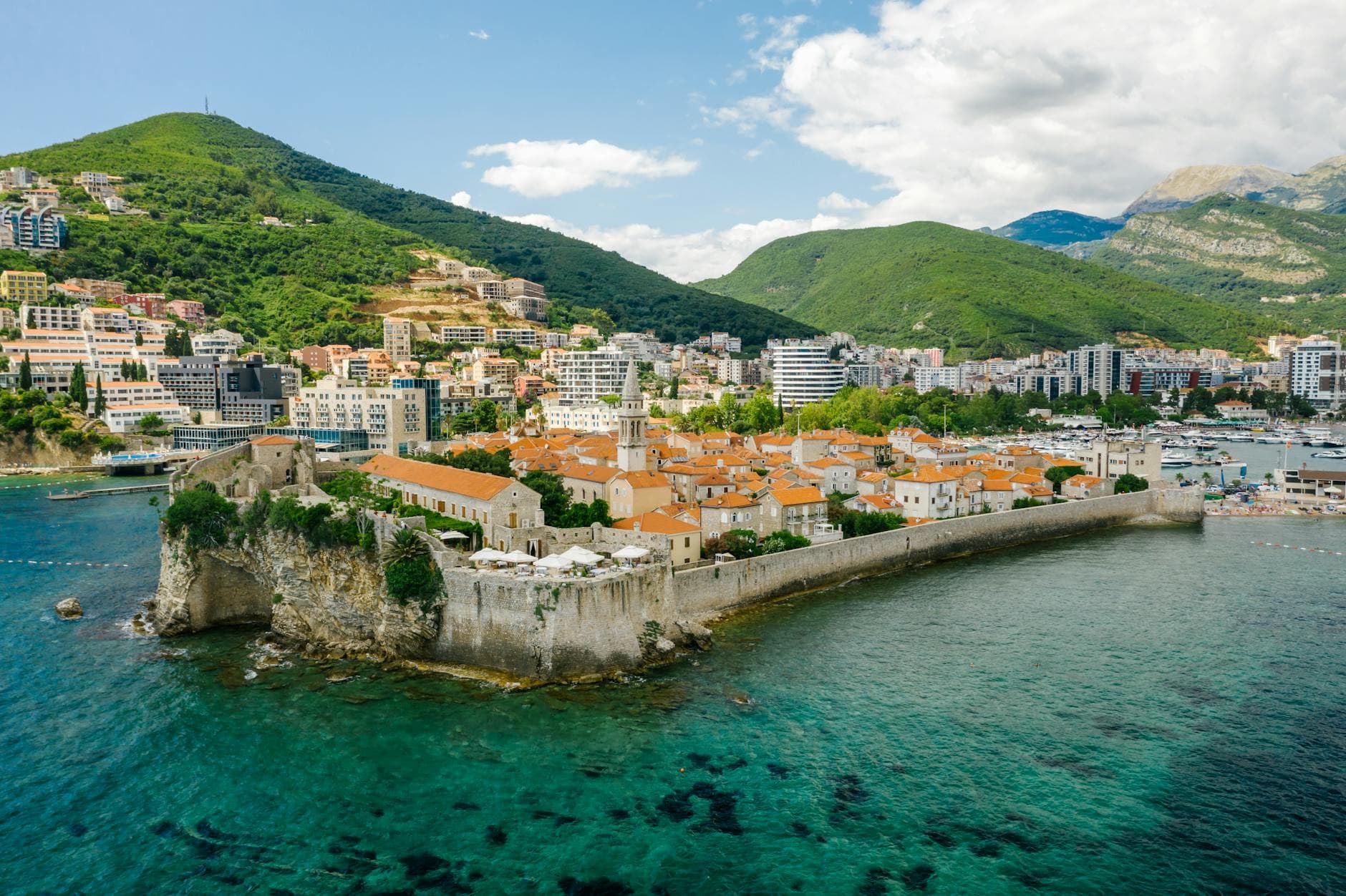 Scenic aerial shot of Budva's historic Old Town along the Adriatic coast.