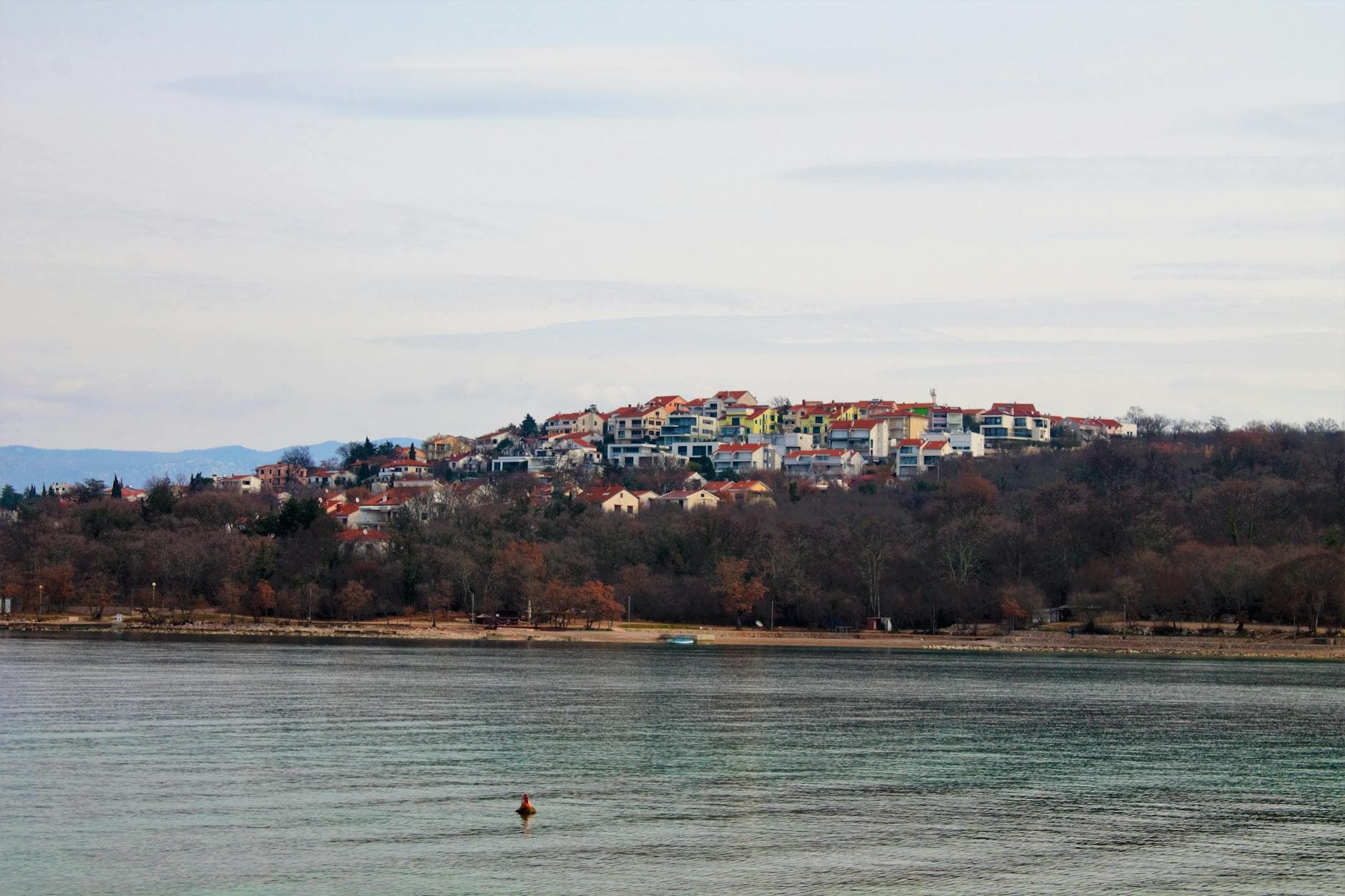 Charming view of Njivice village perched on a hillside by the serene sea in Croatia.