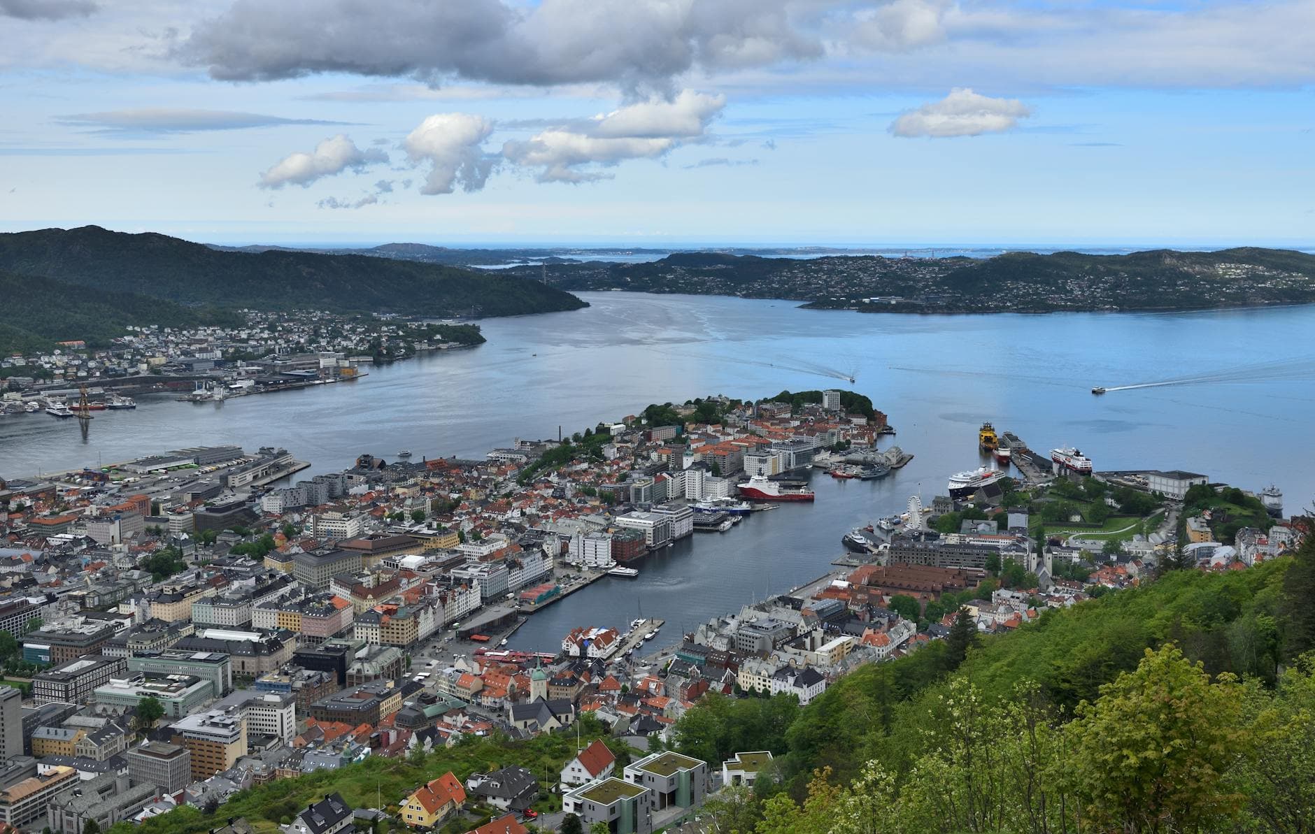 Explore Bergen, Norway's beautiful coastal cityscape captured in this stunning aerial view, showcasing urban and natural harmony.