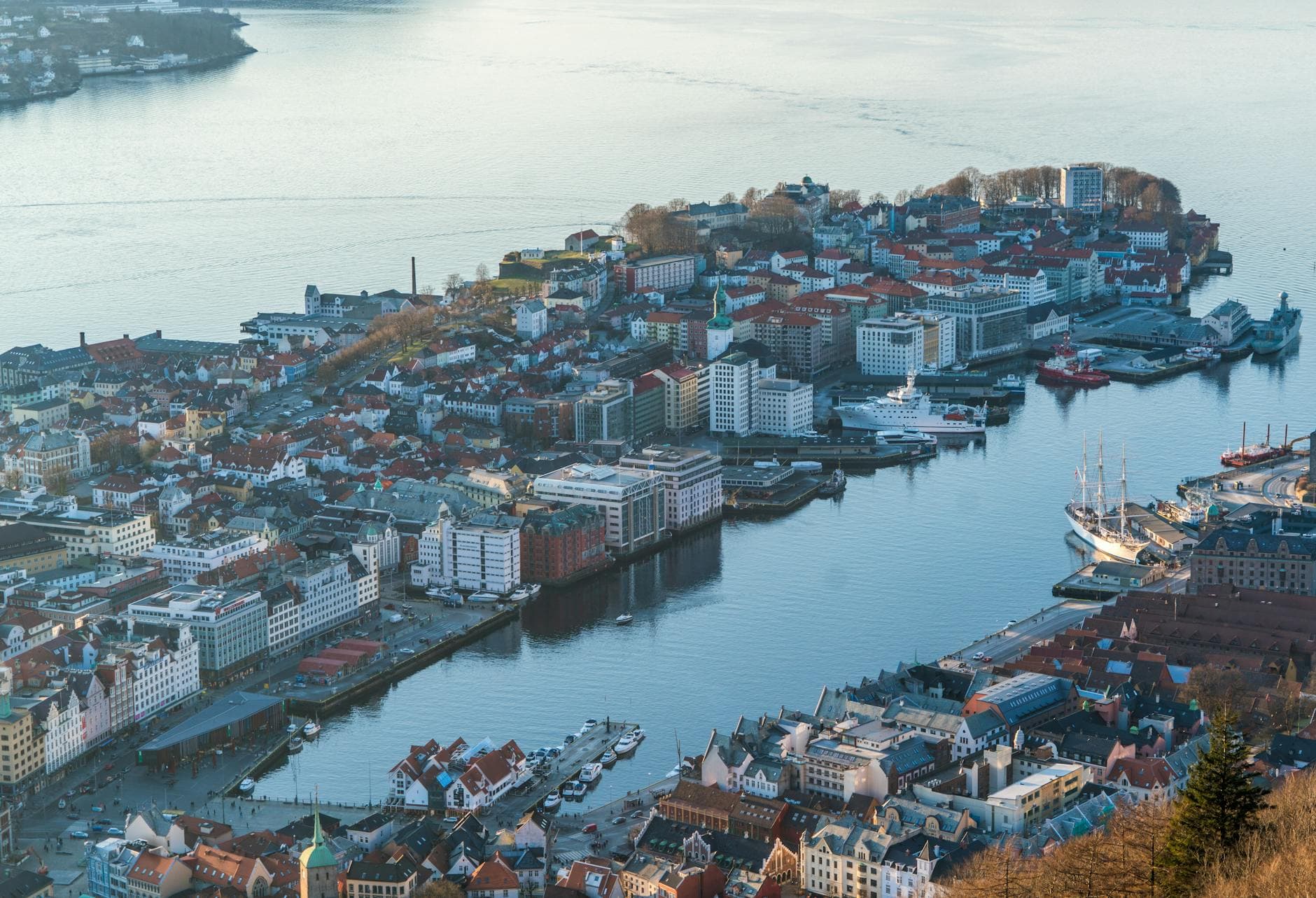 A breathtaking aerial shot of Bergen, Norway, showcasing the harbor and cityscape with boats and waterfront buildings.