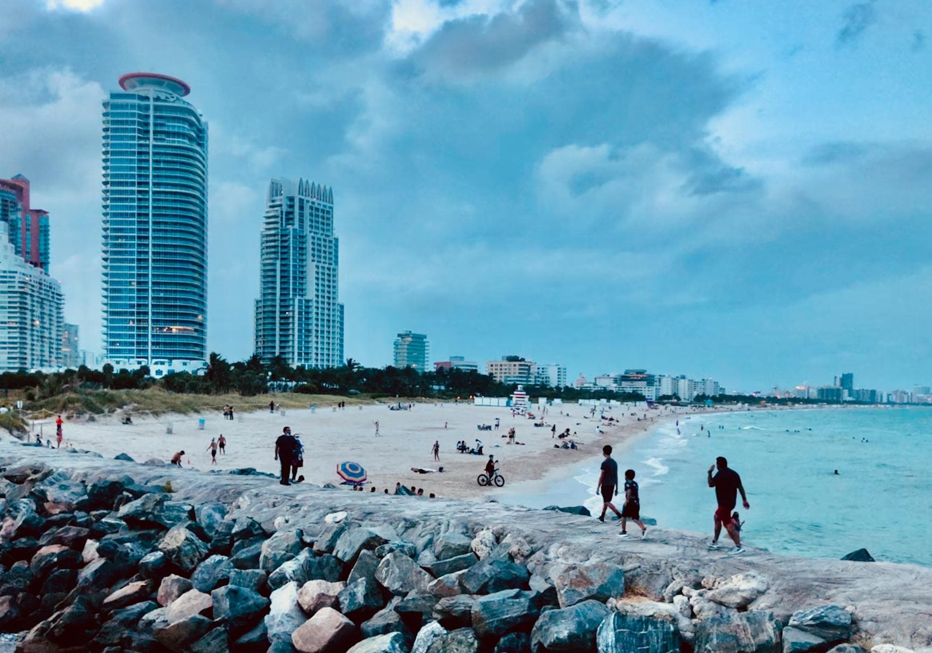 Explore the lively Miami Beach with its stunning skyline and sandy shores under a cool sky.