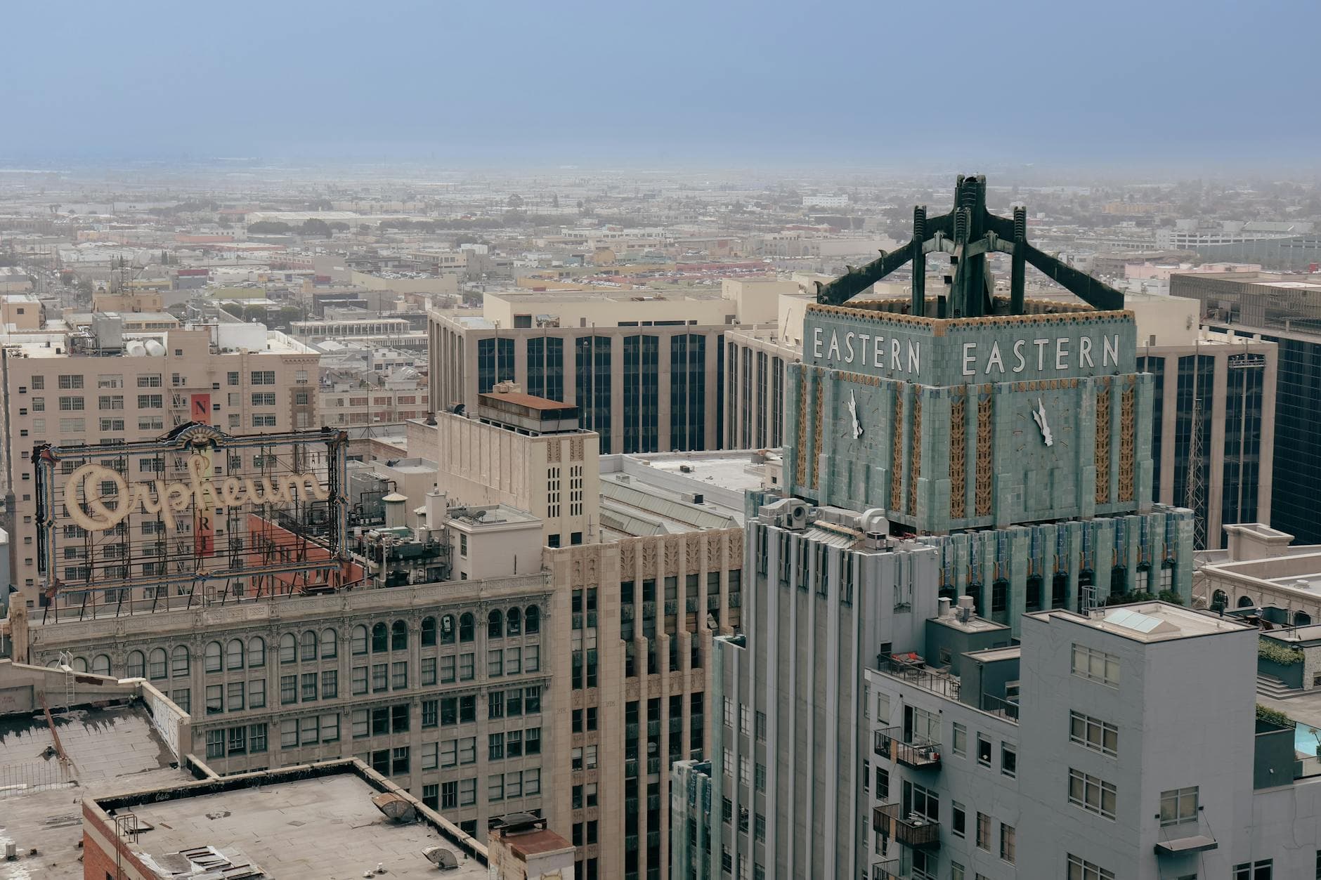 Aerial view of the iconic Eastern Columbia Building and surrounding cityscape in downtown Los Angeles.