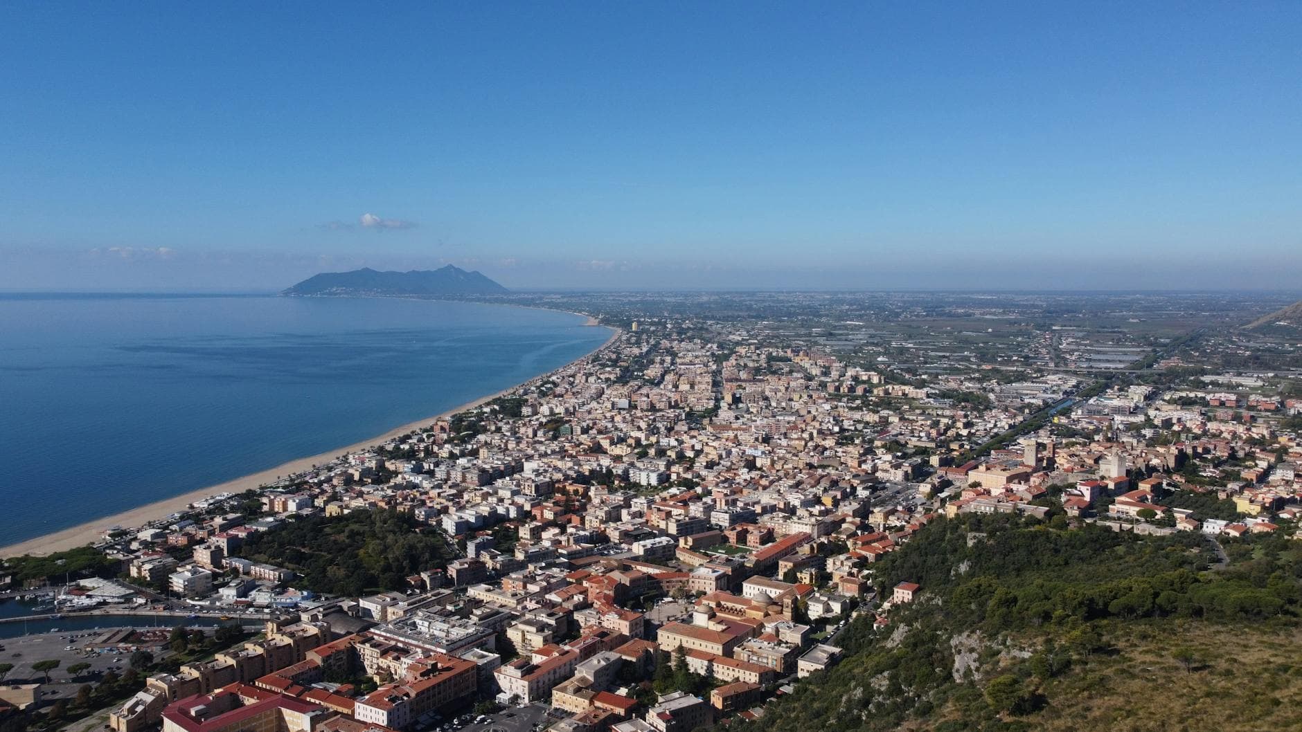 Stunning aerial capture of Terracina, Italy showcasing beach, city, and coastline.