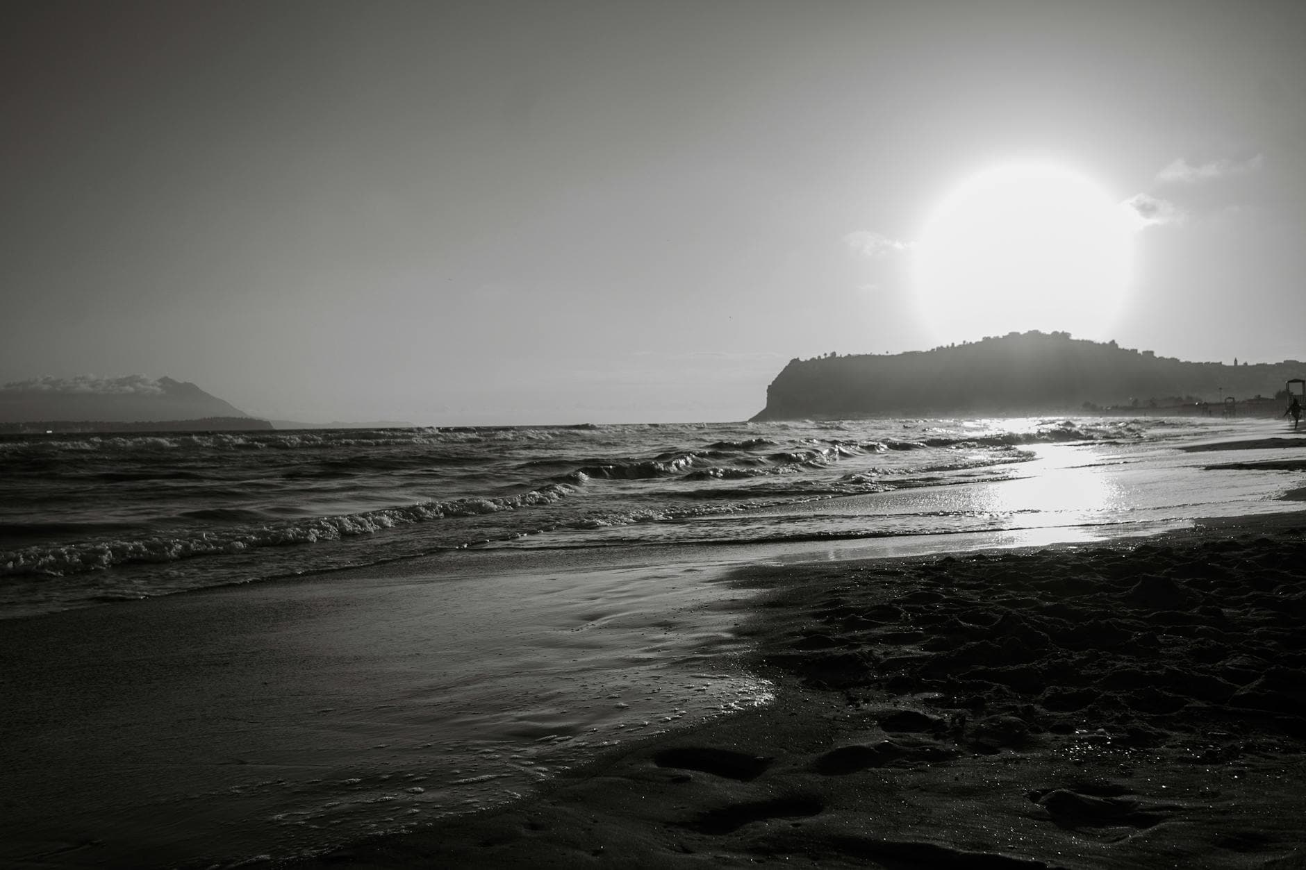 Captivating monochrome sunset view at Bacoli beach in Kampanien, Italy, capturing serene sea waves.