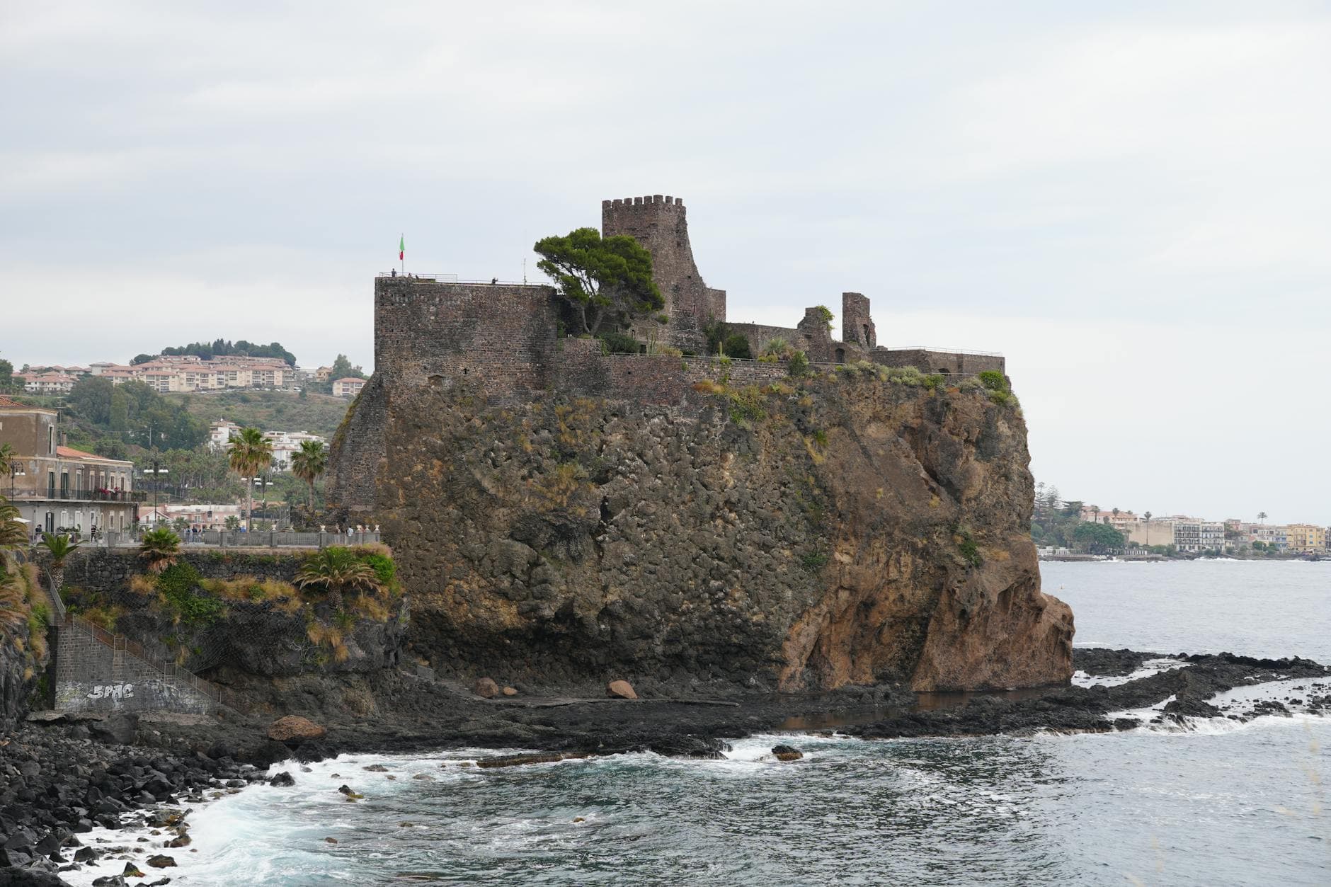 Explore the historic Aci Castello Norman Castle perched on volcanic cliffs in Sicily, Italy.