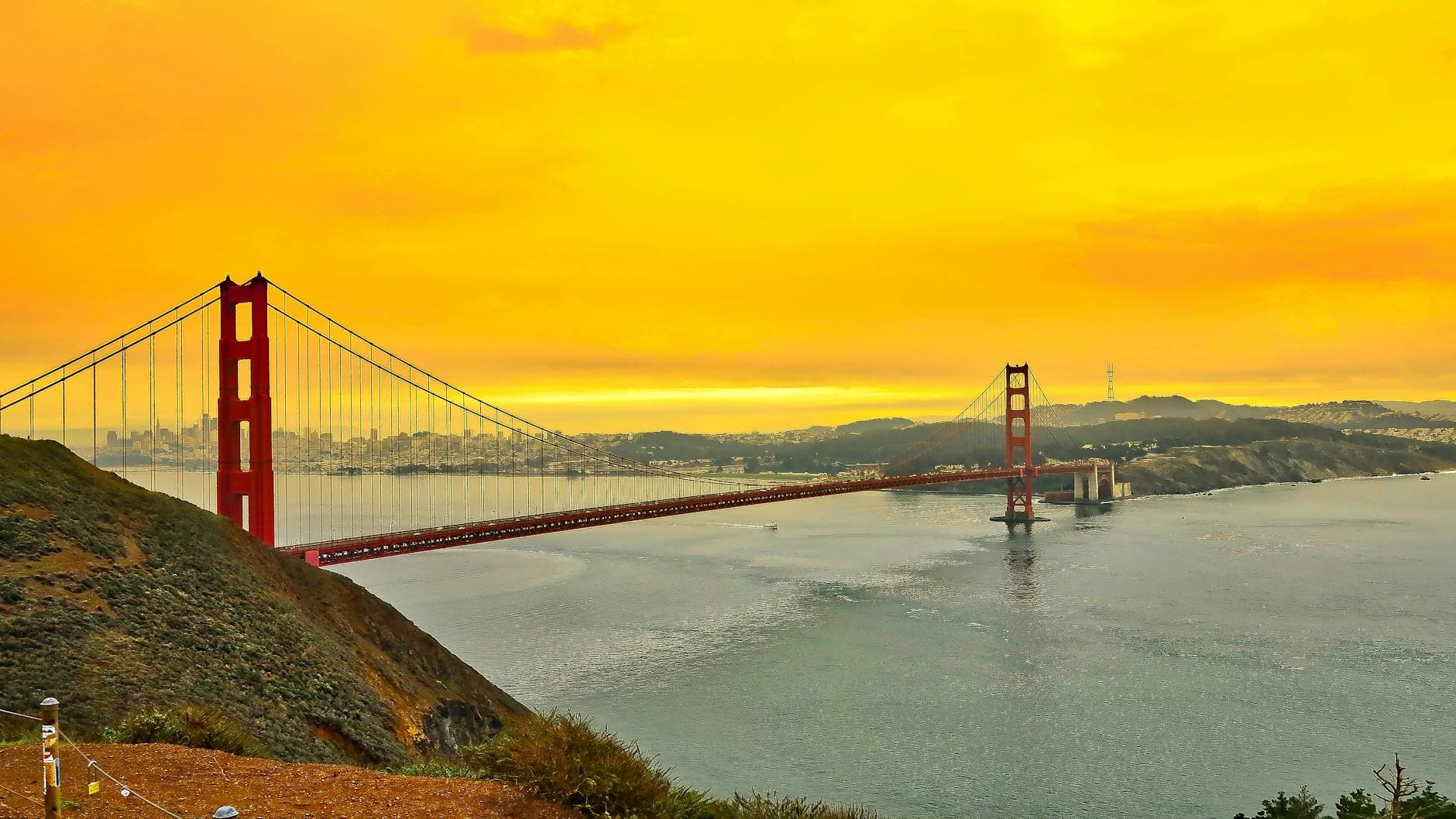 Stunning view of the Golden Gate Bridge at sunset with a vibrant sky over San Francisco Bay.