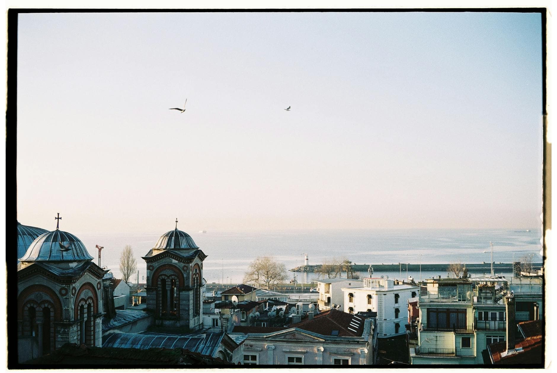 Aerial view of Istanbul cityscape showcasing historic architecture with a sea backdrop.