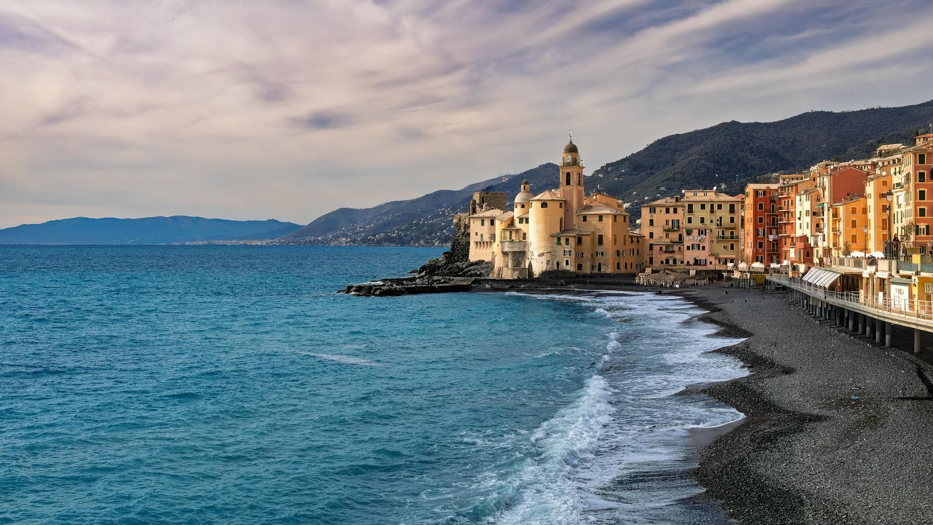 Scenic view of Camogli's vibrant buildings and coastline in Liguria, Italy.