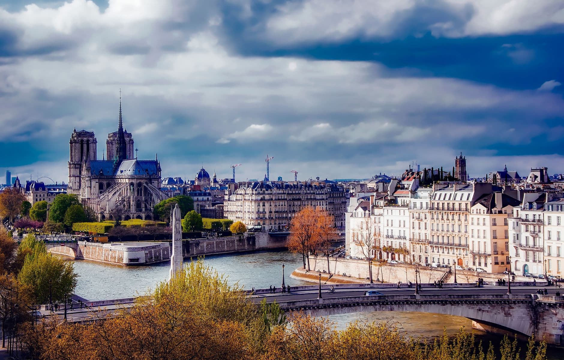 A beautiful view of the Notre Dame Cathedral and Paris skyline over the River Seine.