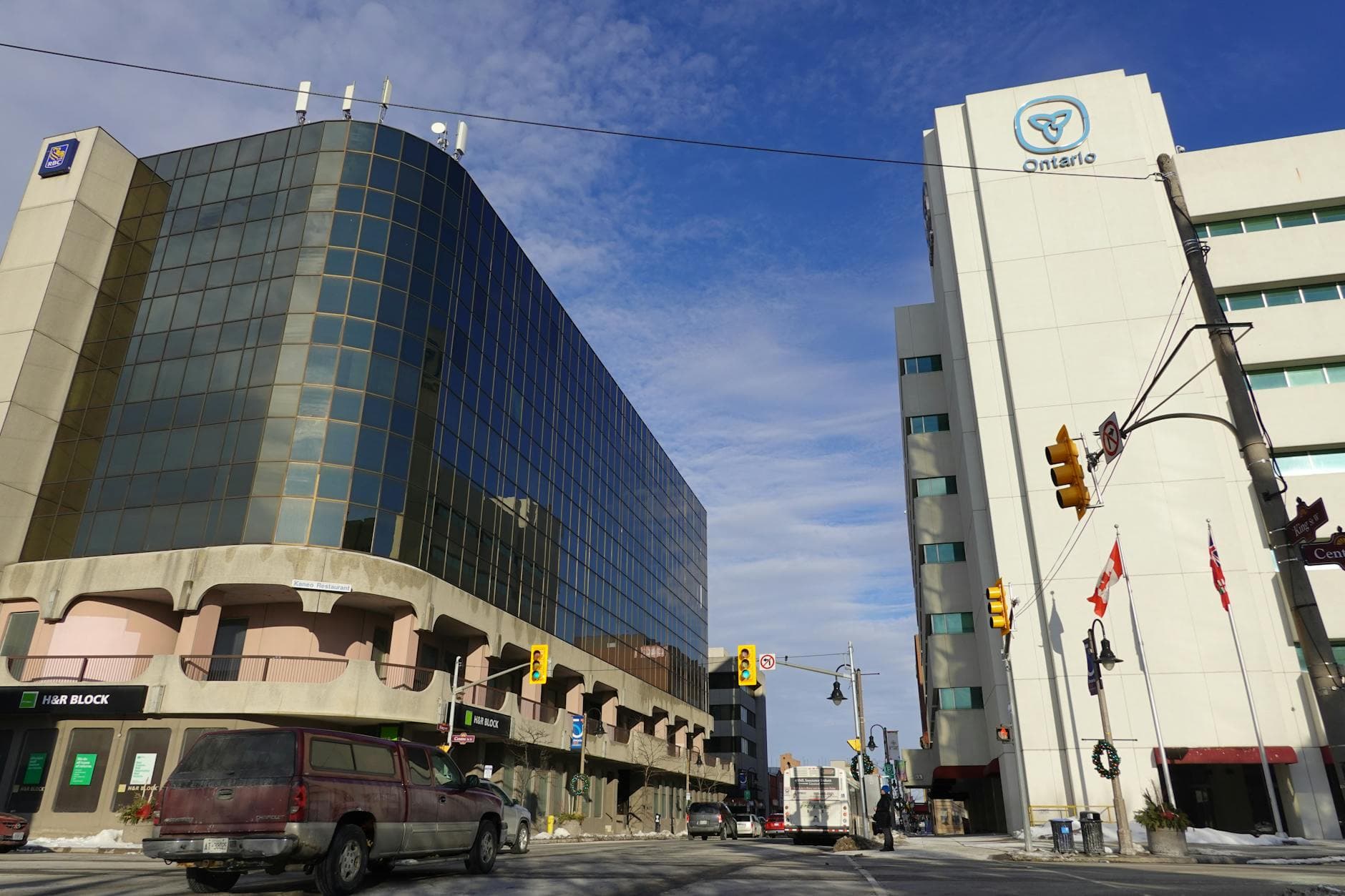 Low angle view of modern office buildings and traffic in downtown Oshawa, Ontario, Canada.