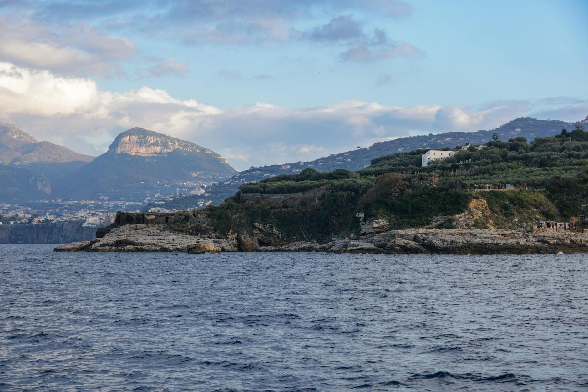 Explore the stunning Mediterranean coast with cliffs and hills in an Italian seaside village.