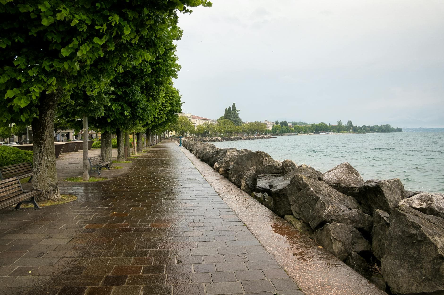 Peaceful view of Lake Garda along the promenade in Desenzano, Italy.