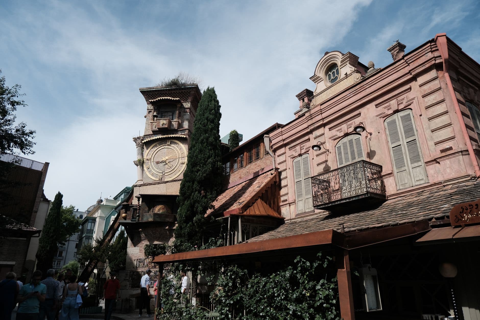 A scenic view of the iconic clock tower in Tbilisi, showcasing historic architecture under a clear sky.