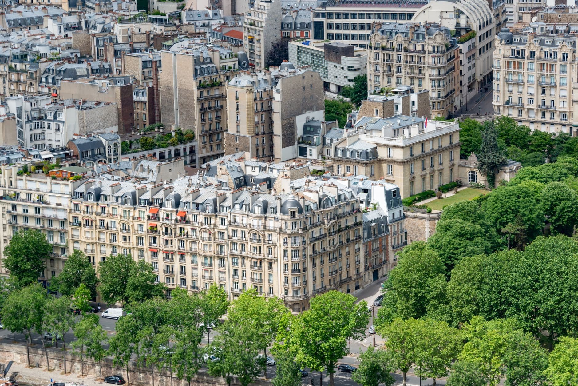 Aerial photo capturing classic Parisian residential architecture in a green urban setting.