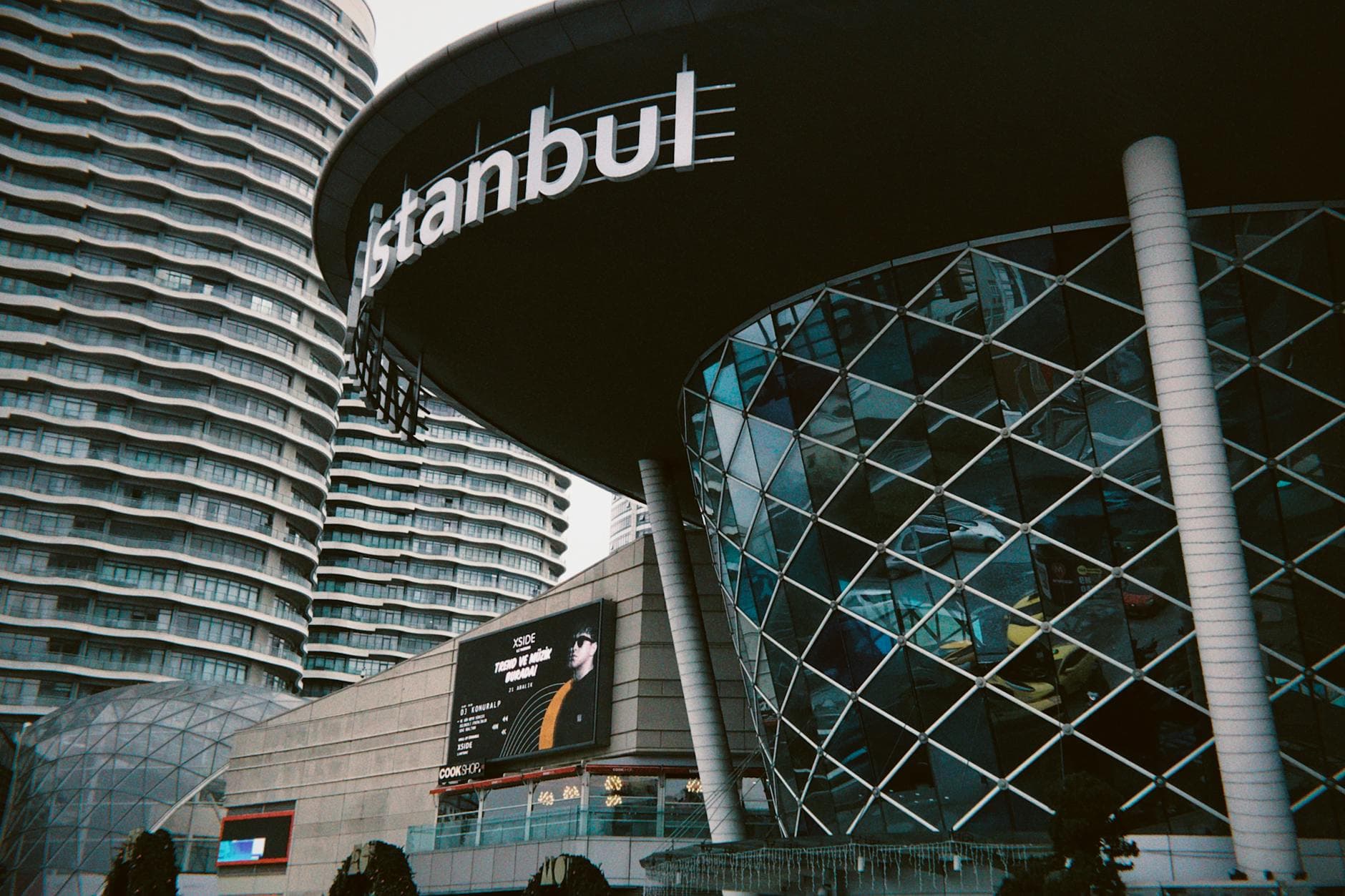 A view of modern architectural buildings in downtown Istanbul, showcasing glass facades and curves.